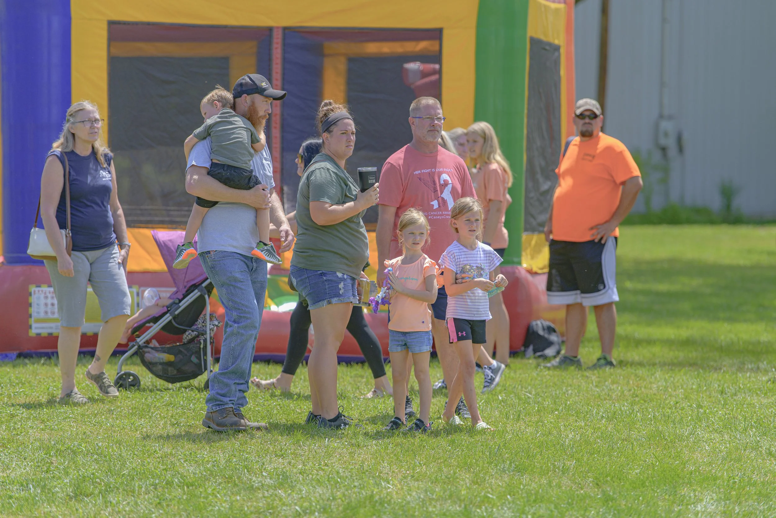 A group stands on the grass in front of a colorful inflatable attraction at the 2022 Silex Festival.