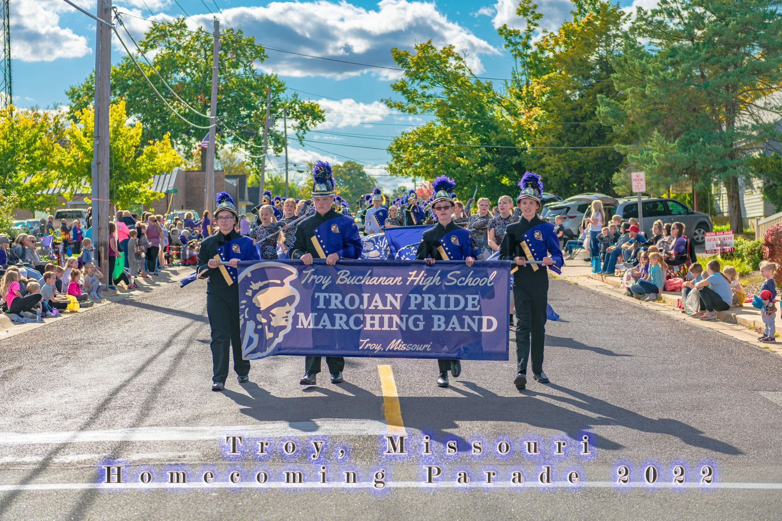 Marchers carry the Troy Buchanan High School Trojan Pride Marching Band banner during the 2022 Troy Homecoming Parade.