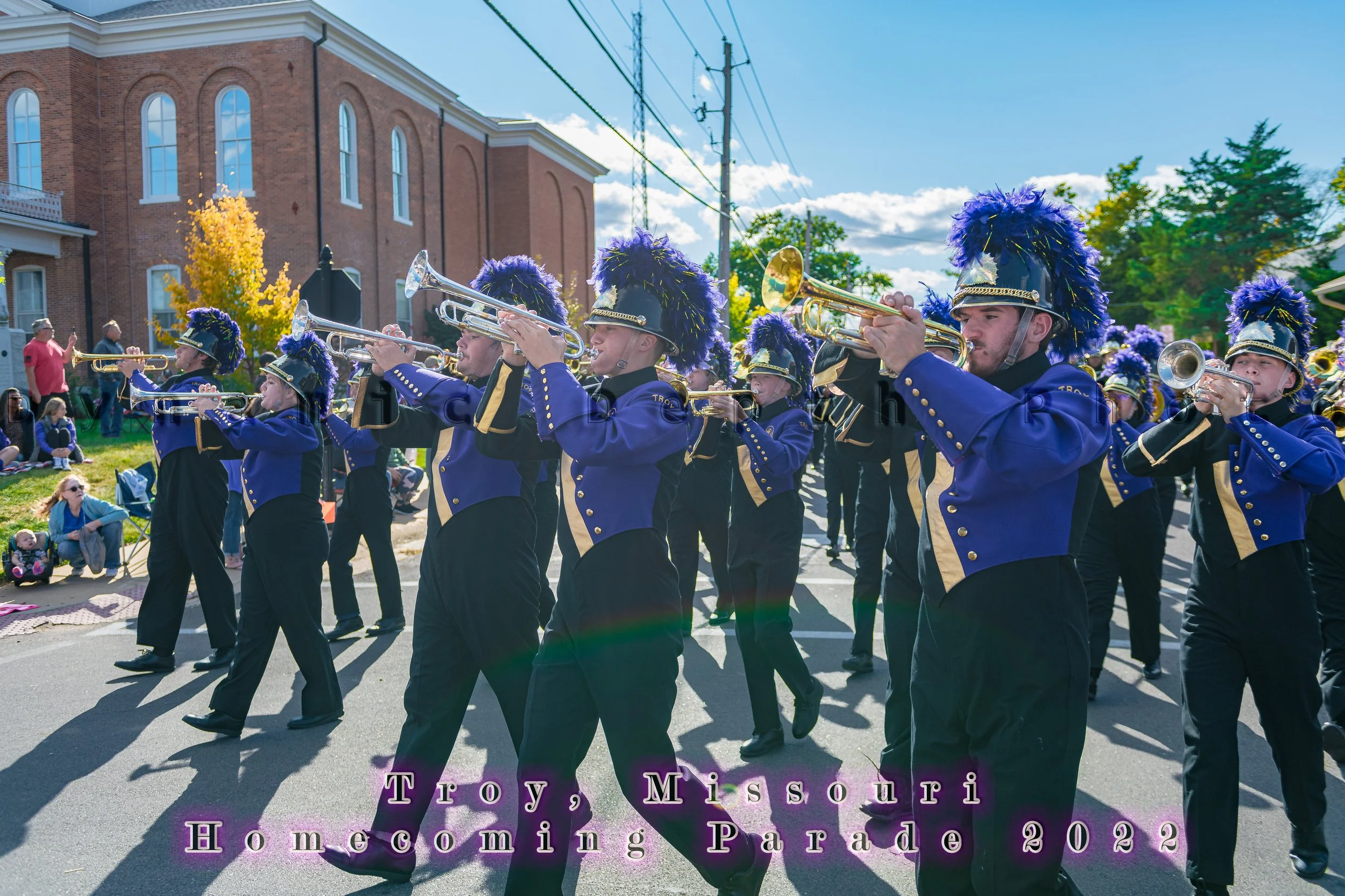 Trumpet players march with their instruments raised during the 2022 Troy Homecoming Parade.