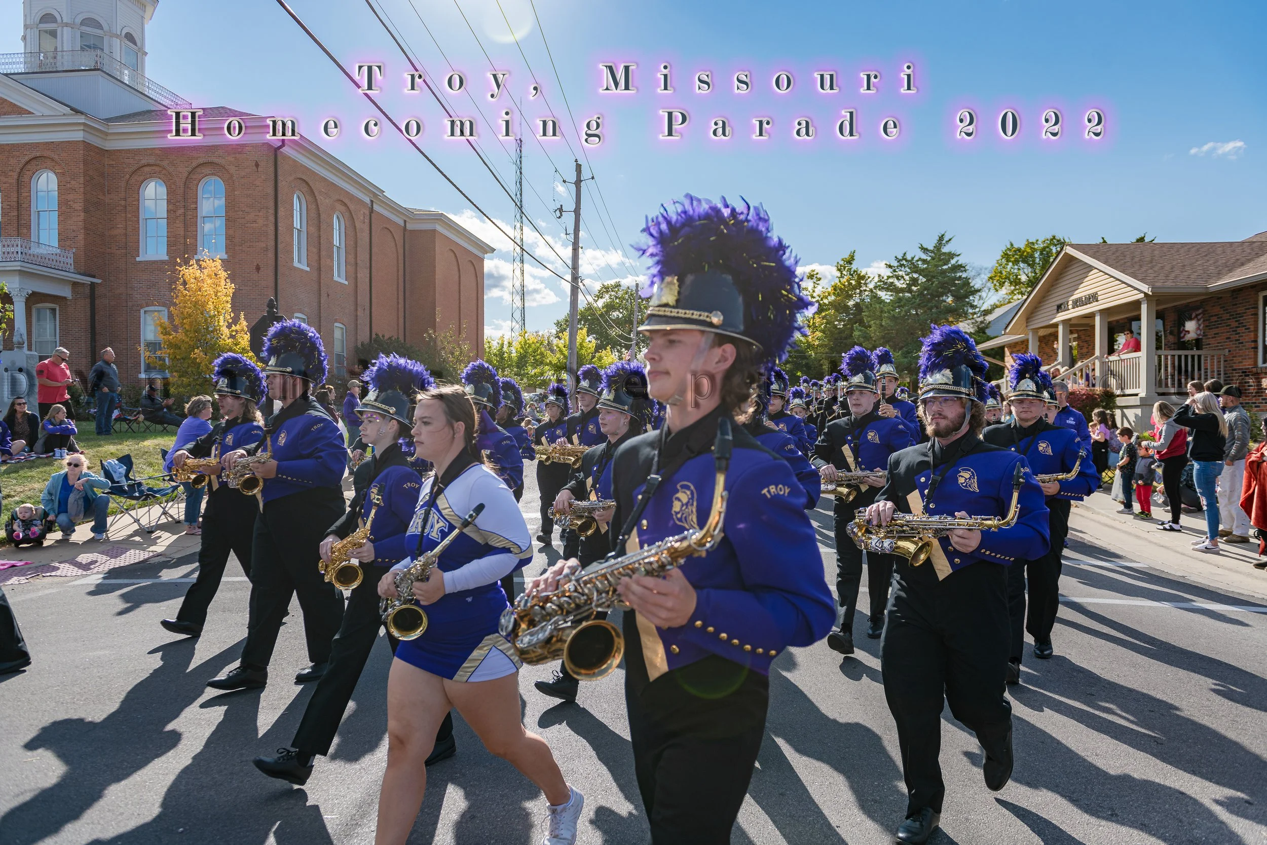 Saxophone players march past roadside spectators during the 2022 Troy Homecoming Parade.