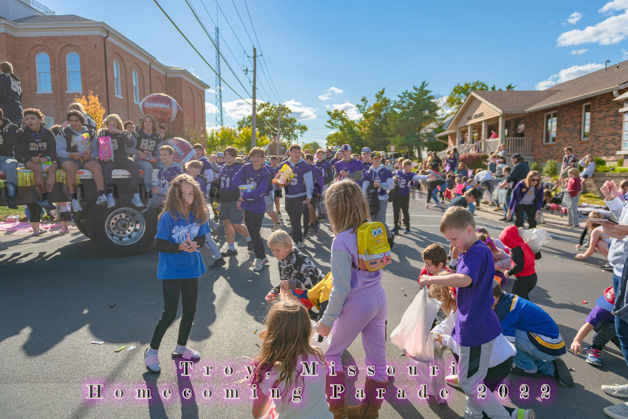 Children gather near the roadside as a float passes during the 2022 Troy Homecoming Parade.