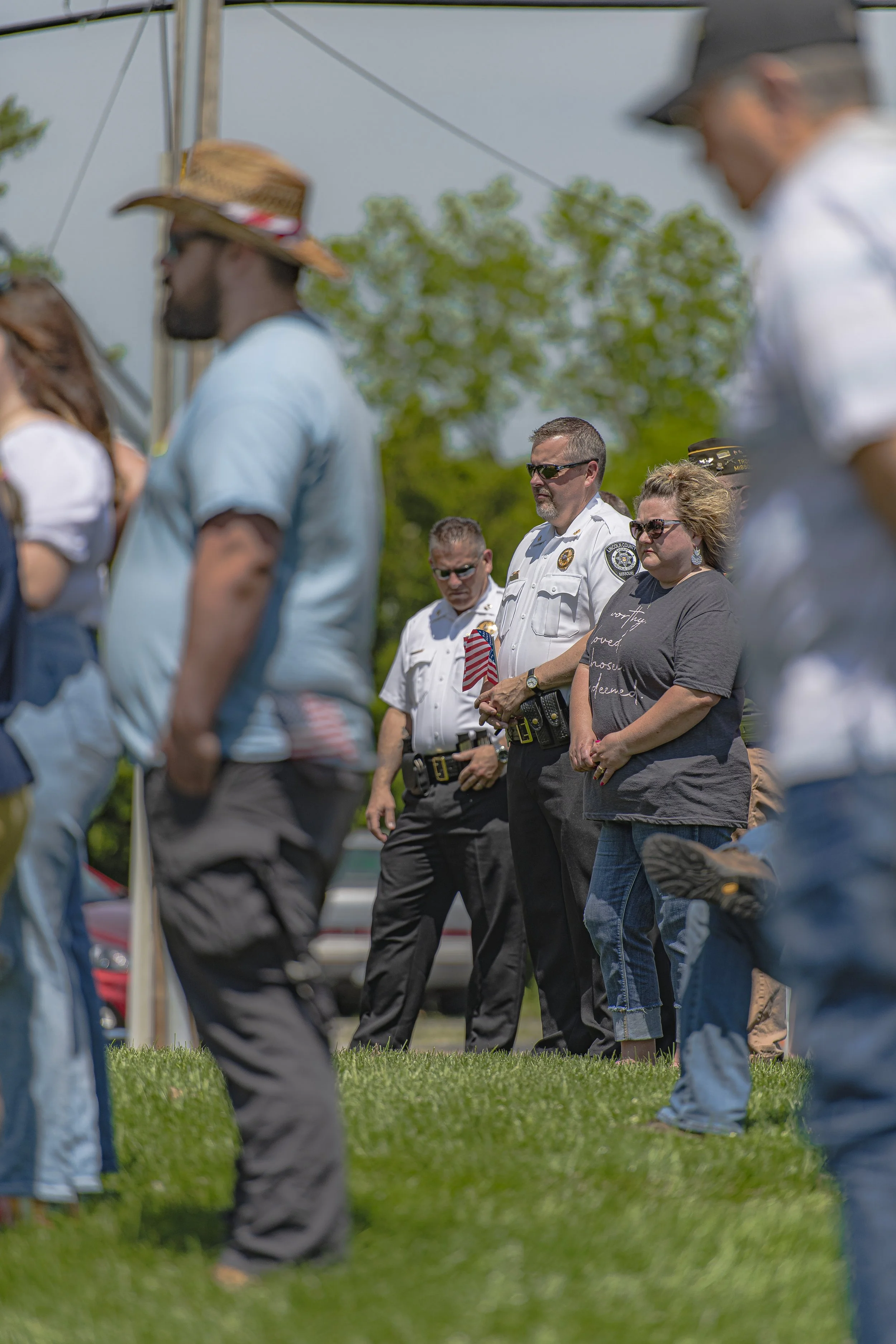 Uniformed personnel and other attendees stand among the crowd at the 2022 Lincoln County Memorial Day service.