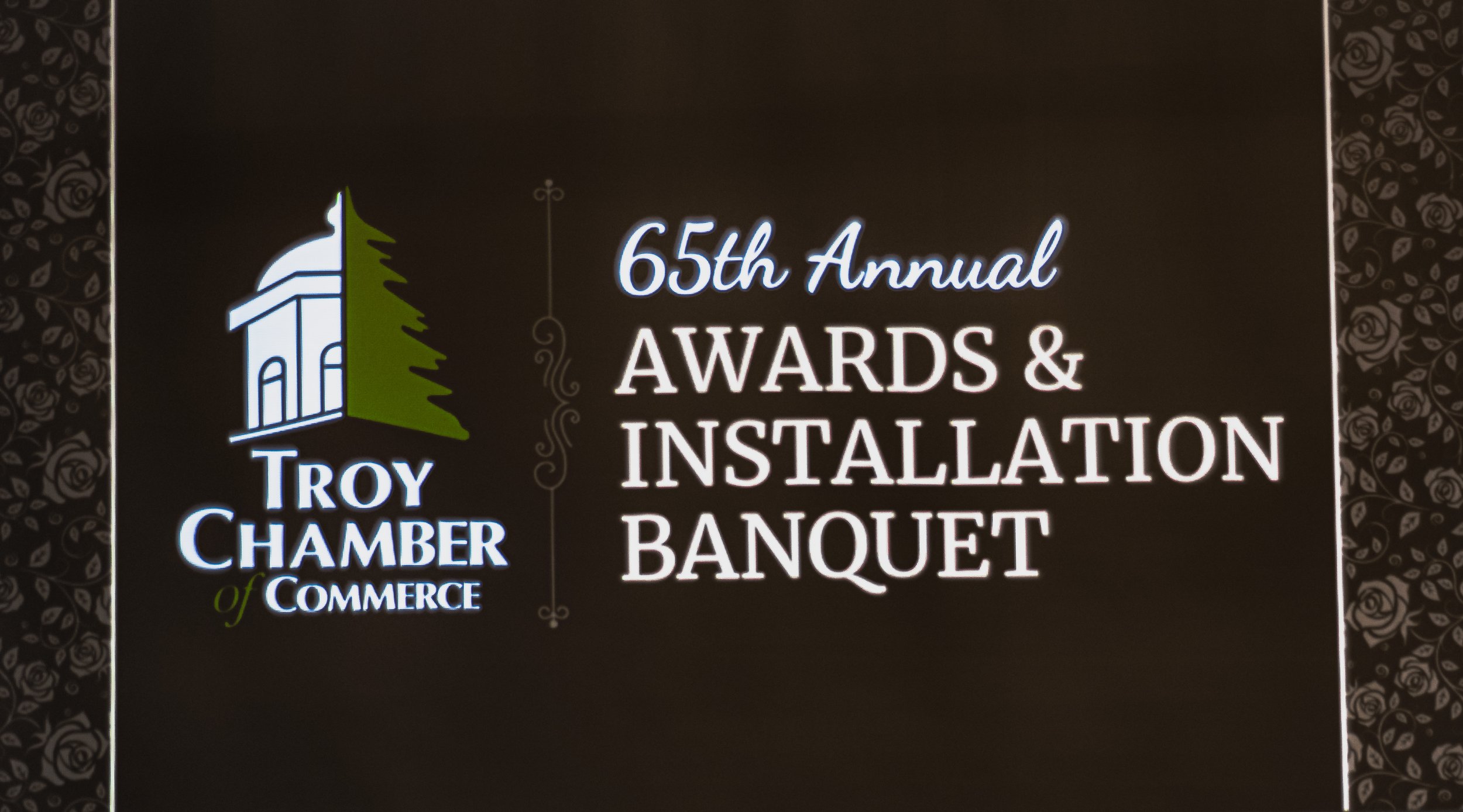 Display reading “Troy Chamber of Commerce” and “65th Annual Awards & Installation Banquet.”