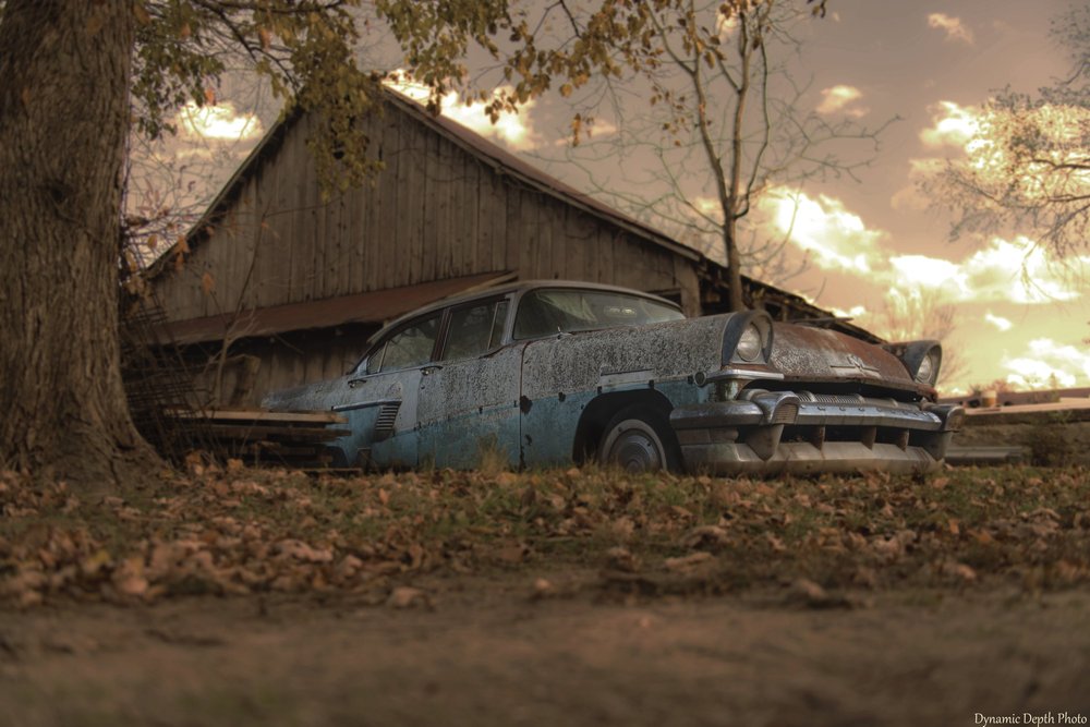 Artistic/Composite Photos — a weathered car beside a barn