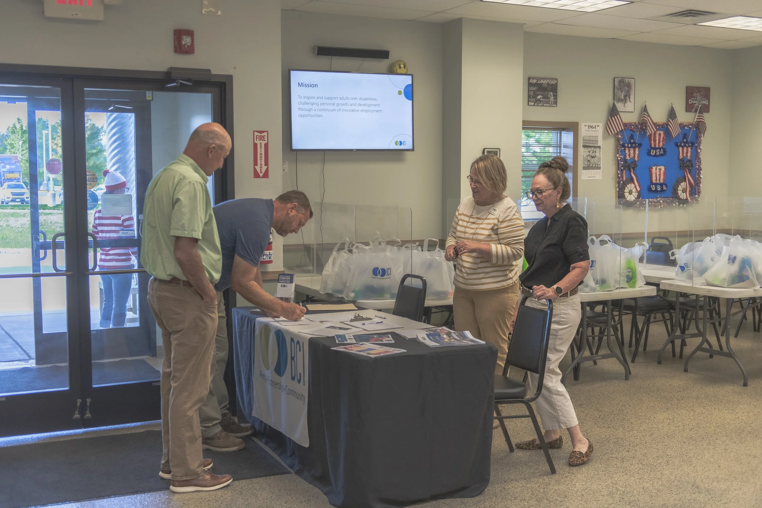 Visitors gather at an information table near the entrance at the 2022 BCI Open House.