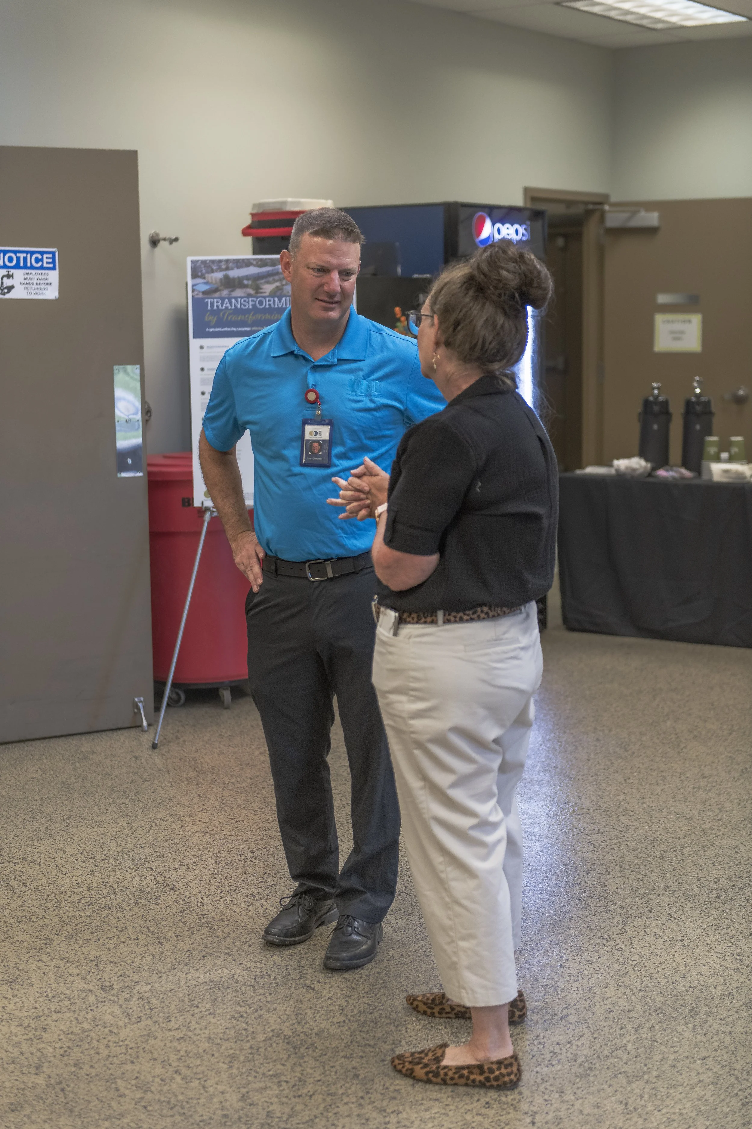 Two attendees talk in the reception area at the 2022 BCI Open House.