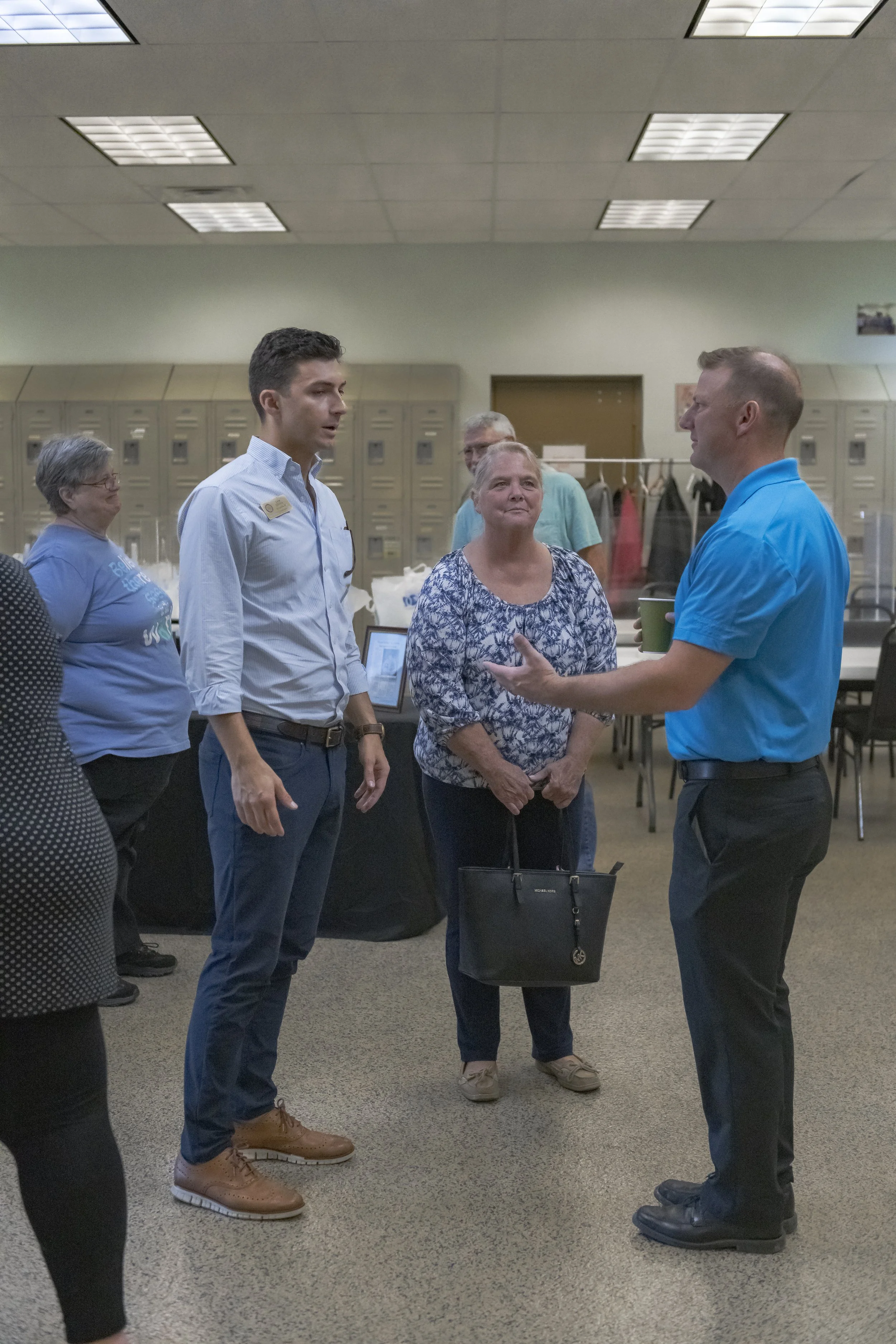 A guide talks with visitors in the reception area at the 2022 BCI Open House.