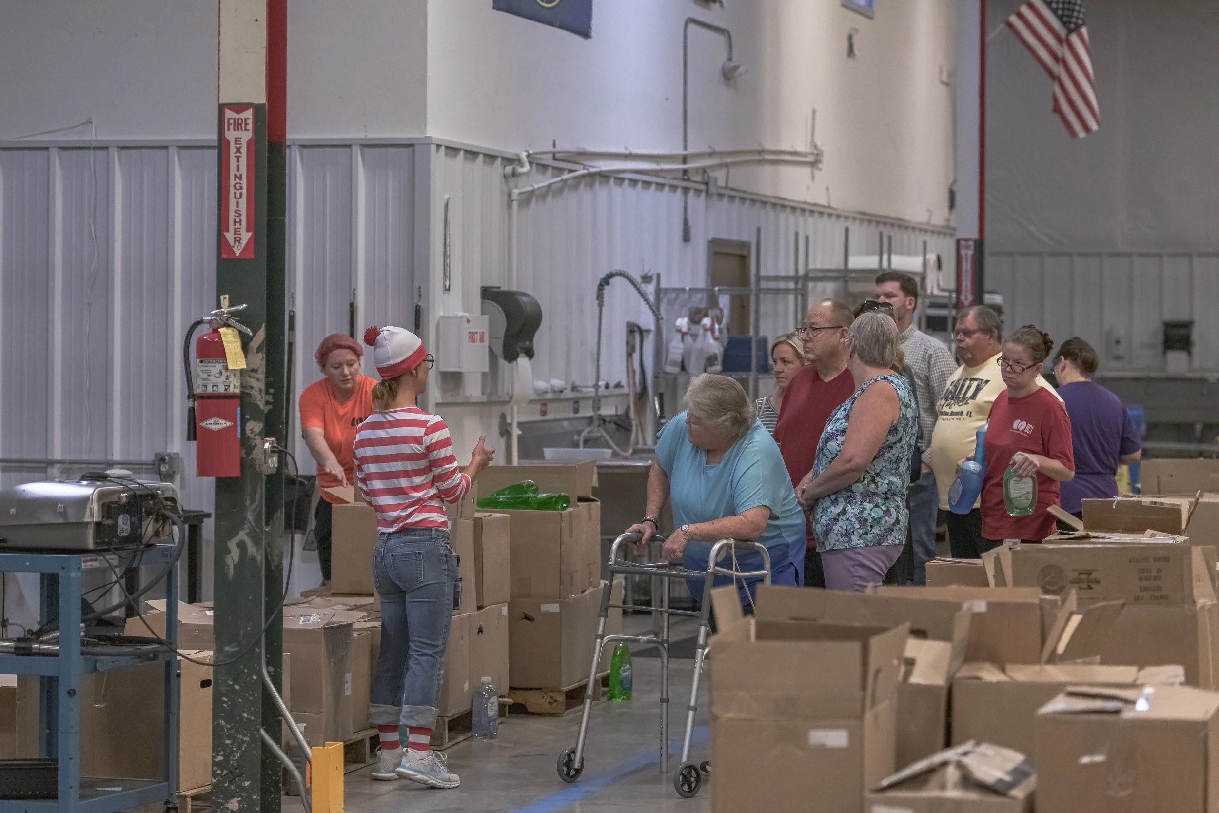 A group tours an aisle through the production area at the 2022 BCI Open House.