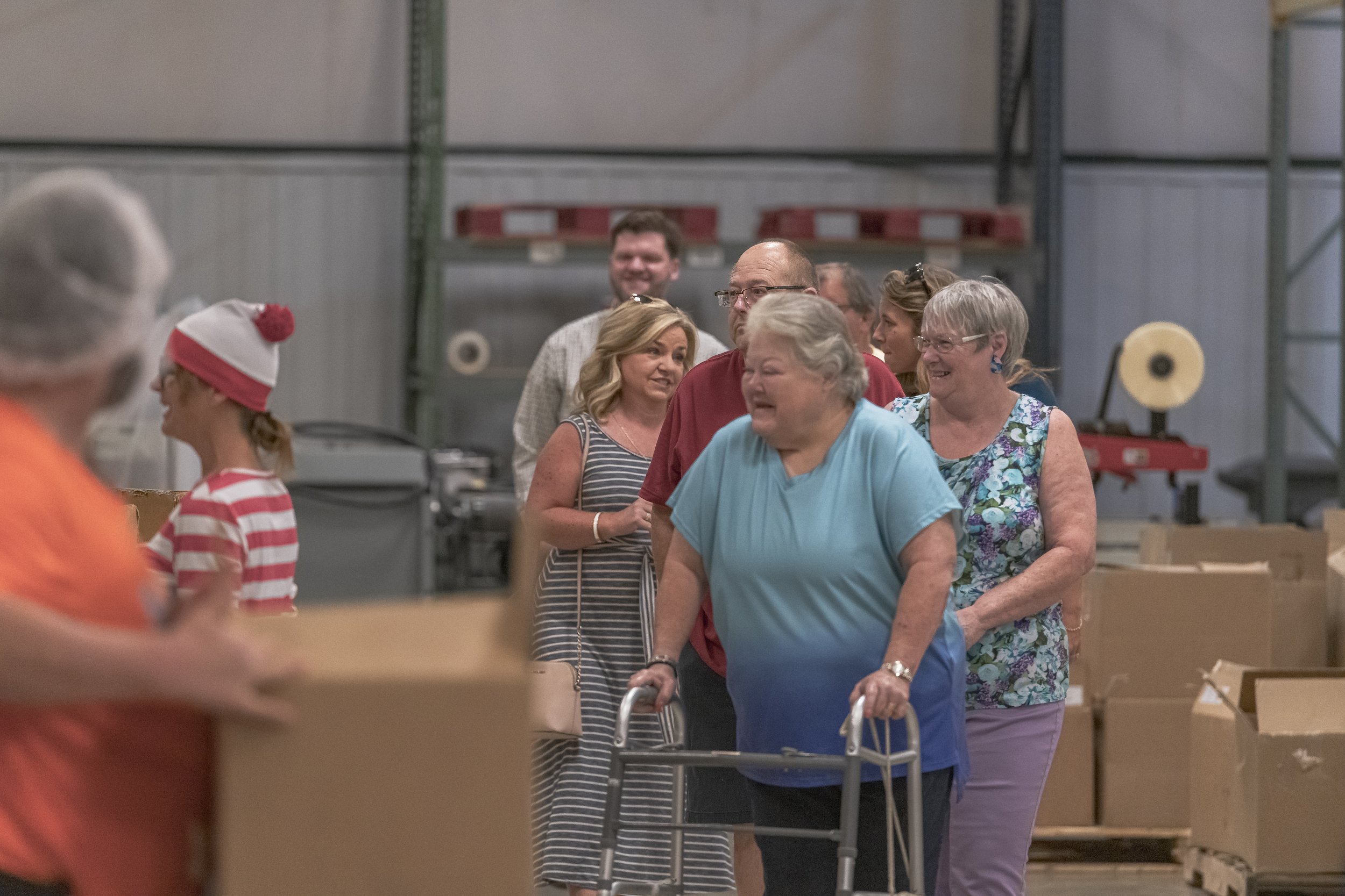 Visitors move between cartons during the facility tour at the 2022 BCI Open House.