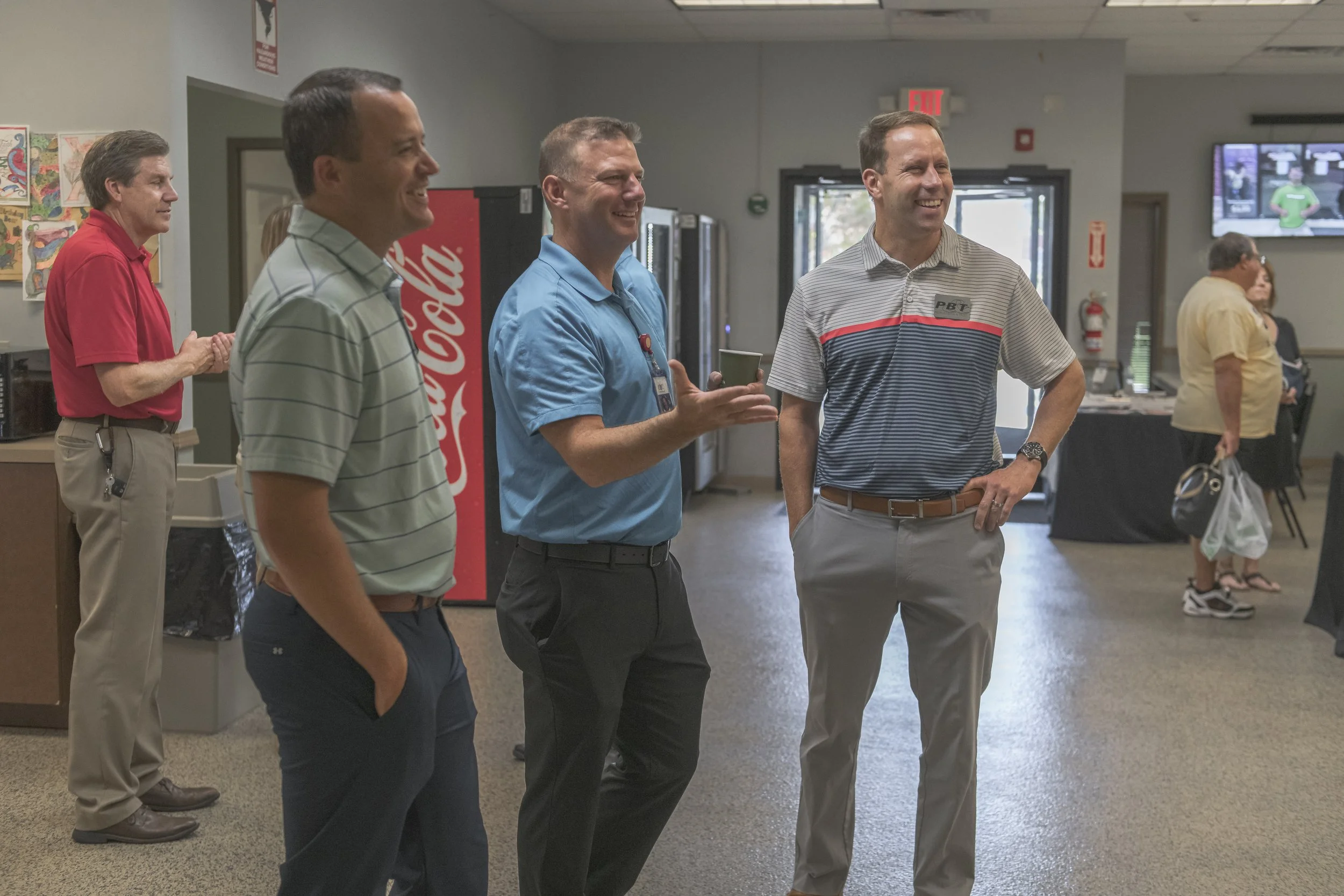 Attendees converse near the vending machines in the reception area at the 2022 BCI Open House.