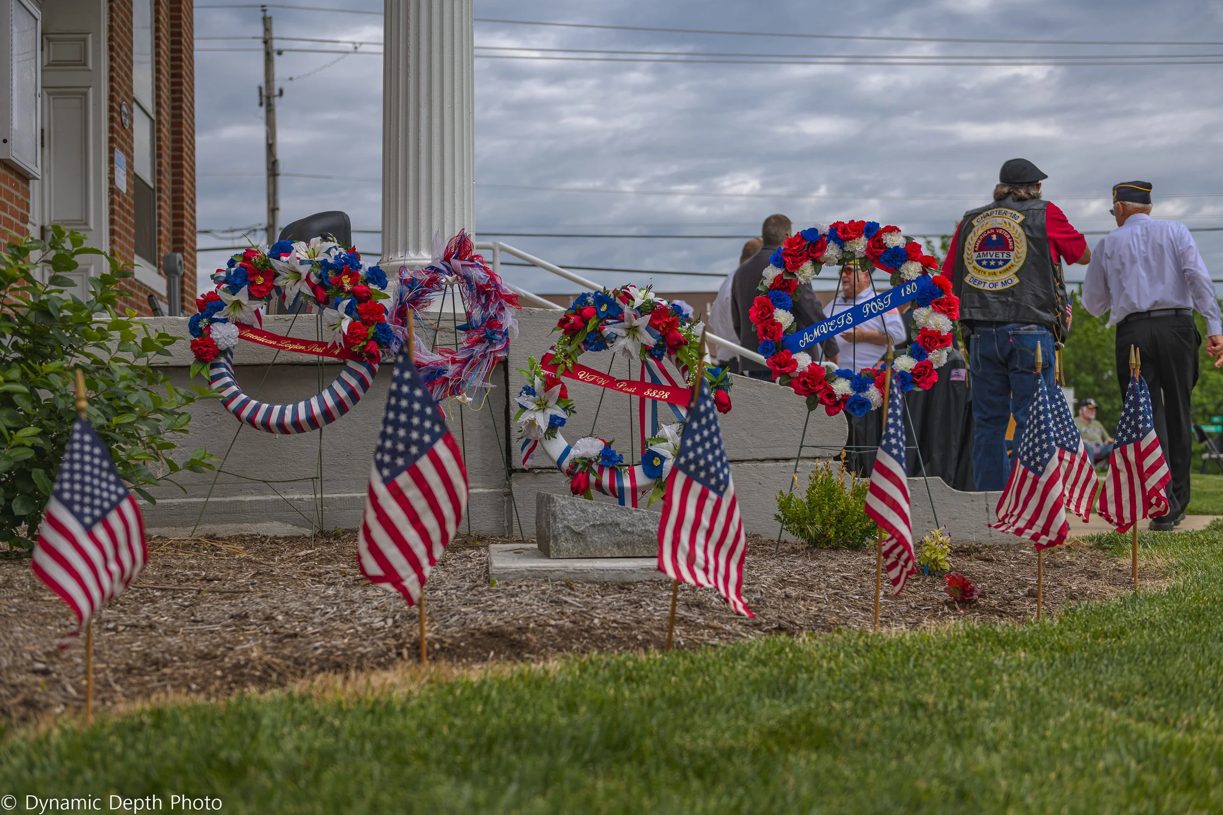 Patriotic wreaths and small American flags line the memorial garden during the 2021 Memorial Day Service.