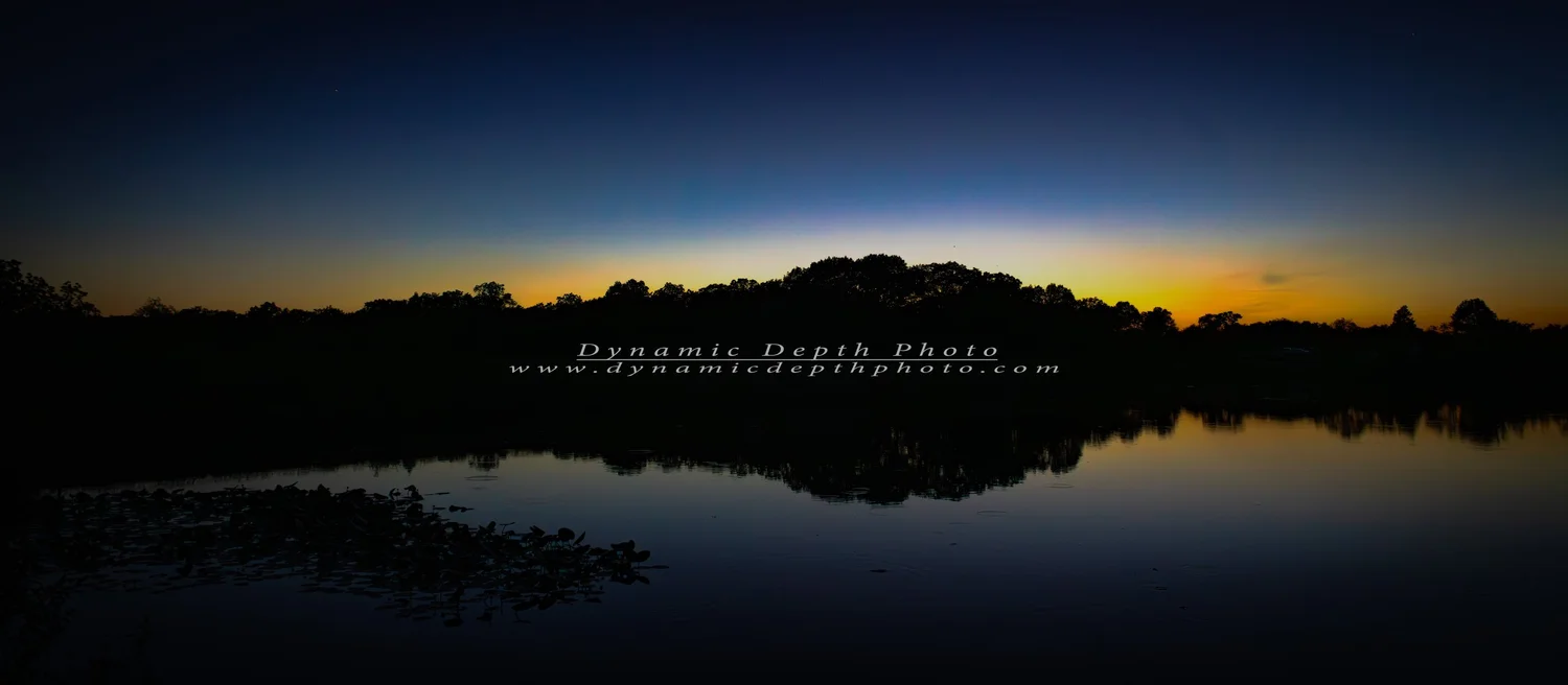 Twilight Reflections on Still Water. Visible: twilight, water reflections, treeline.