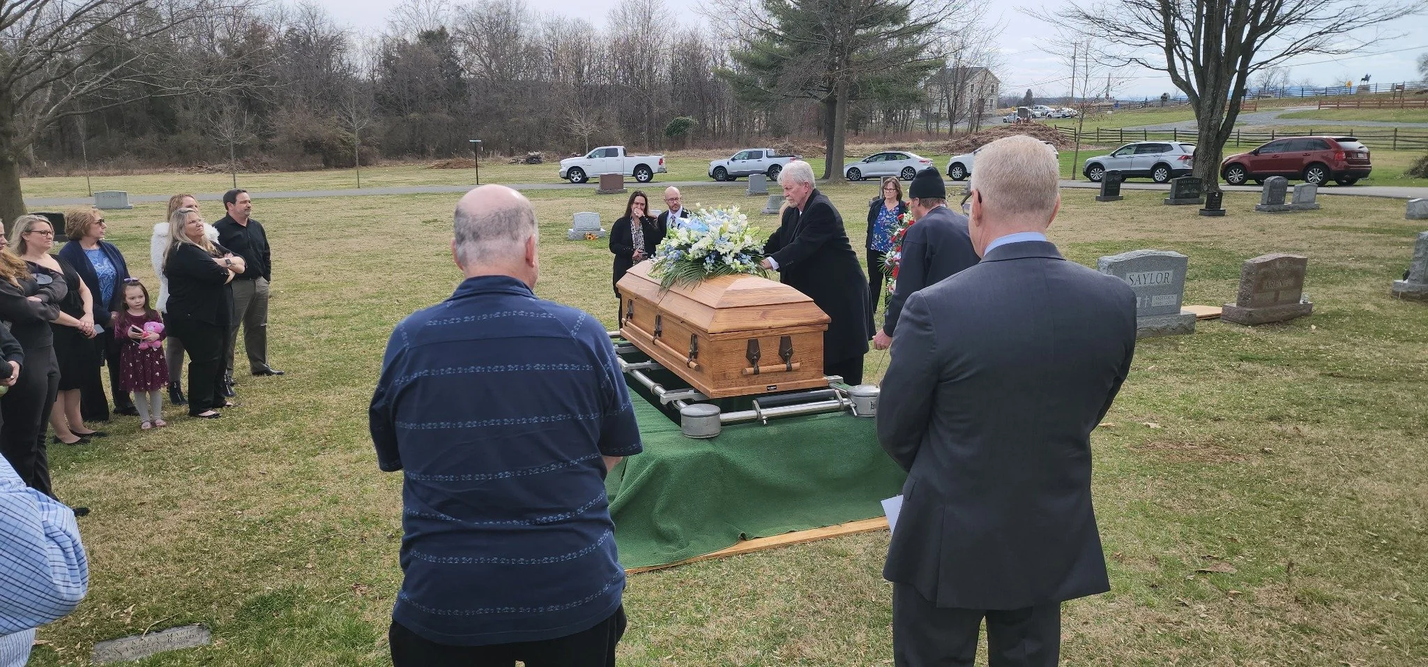 Family and friends gathered around the casket at the cemetery