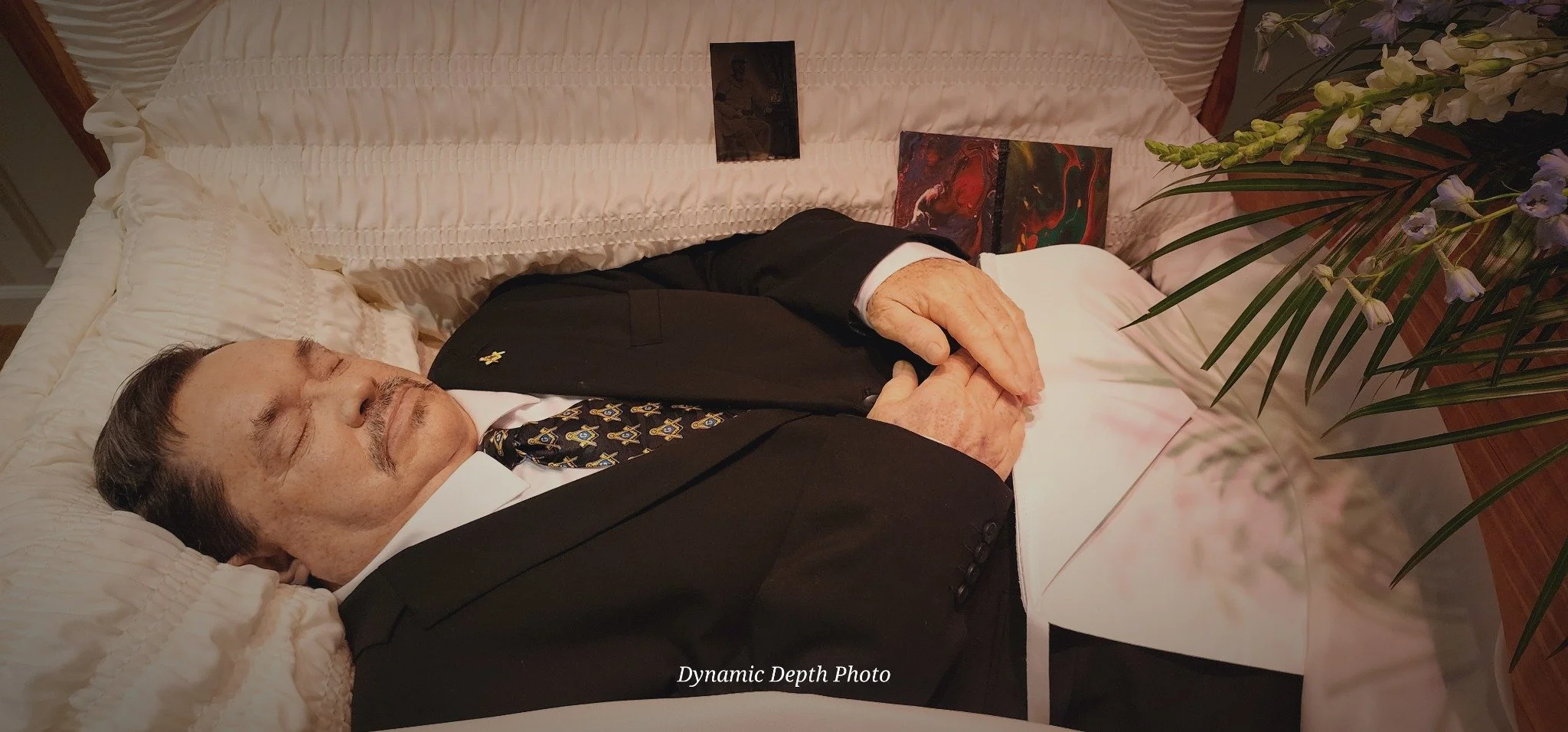 James L. Dye, Sr. resting in his casket with flowers beside him