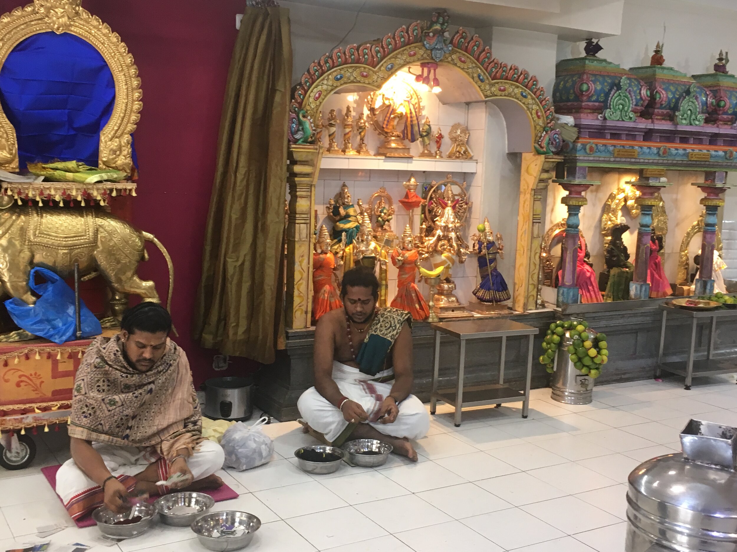 Priests making garlands