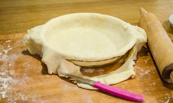 Using a sharp knife, cut off excess dough along the edge of the pan.