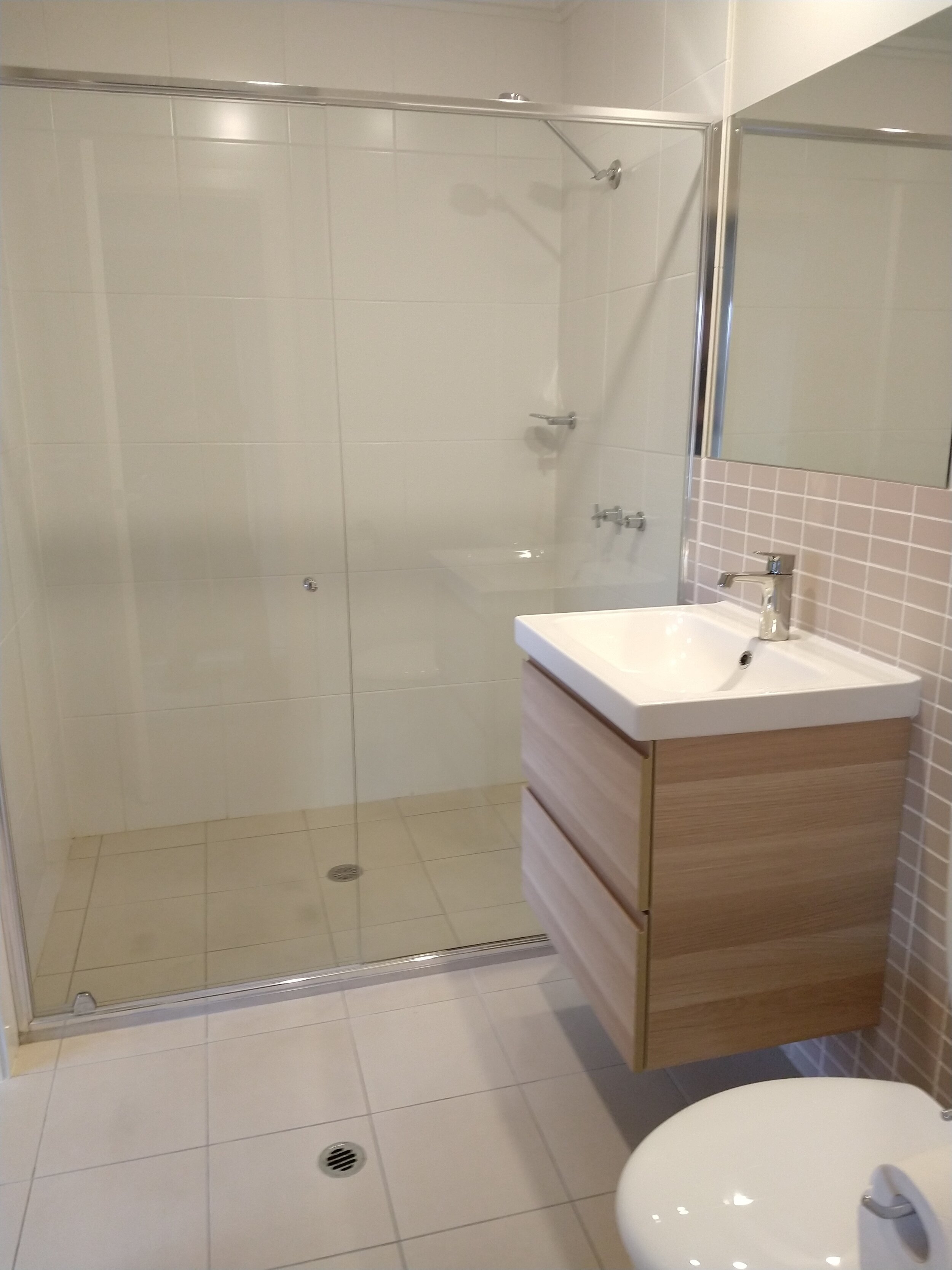 Modern two-way bathroom, generous walk-in shower, updated vanity, tastic heater.
