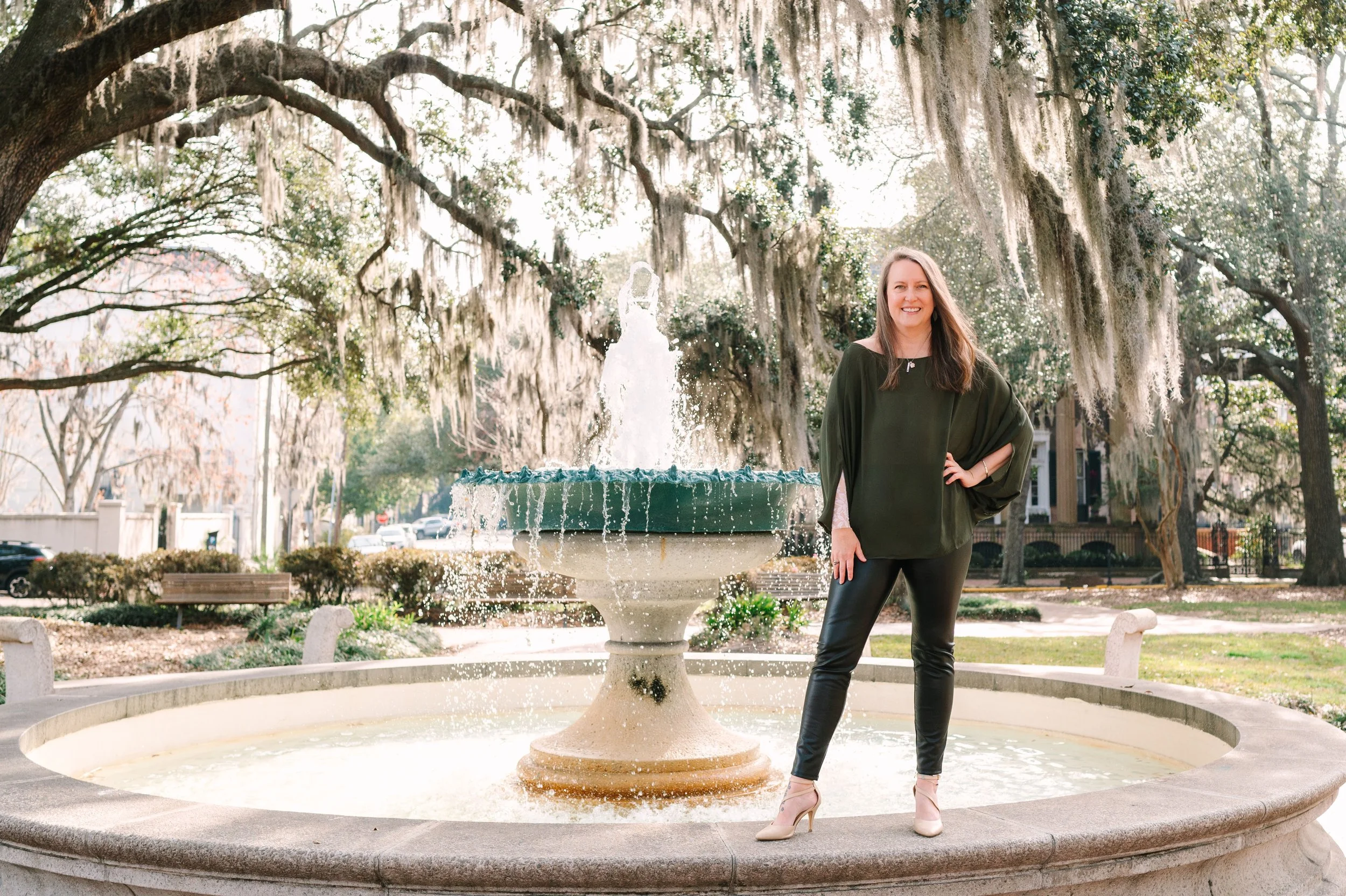 amy capello standing by a fountain in savannah