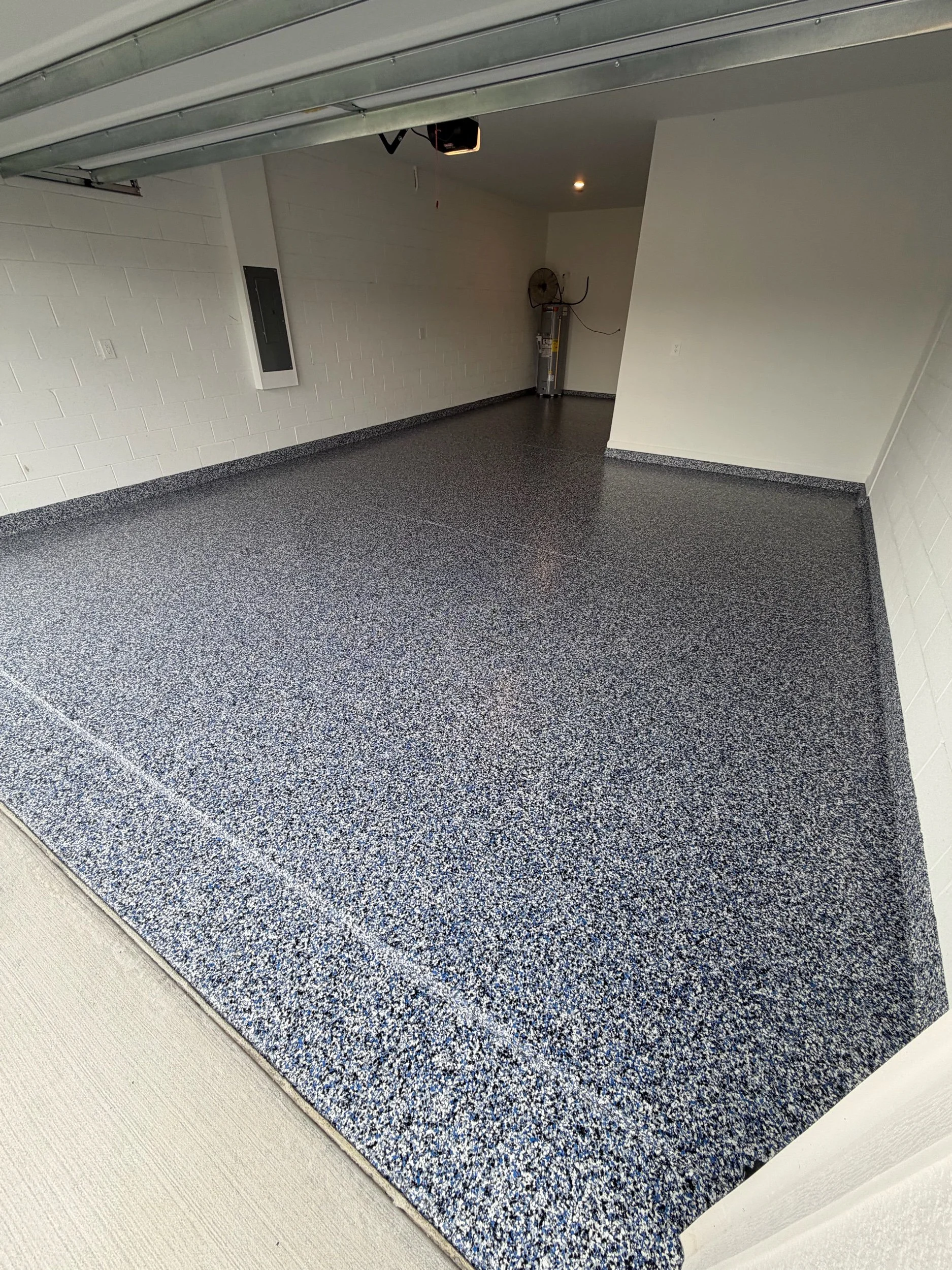      

 
   This epoxy garage floor install was all about clean lines and a bold finish. The highlight is the Orbit flake blend—a mix of blue, white, and black that adds just the right amount of depth and movement without overpowering the space.    W