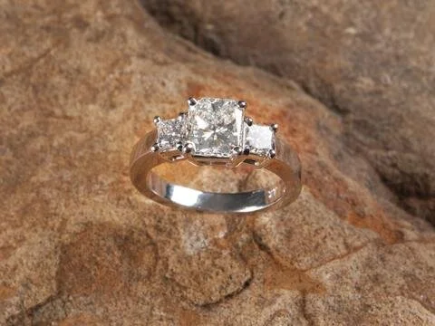 This three stone ring from Secrète's catalog features a flawless radiant cut in the center- notice how it has lopped off corners like an emerald but lots of facets like a princess.