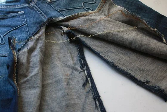 Denim jeans with the inside seam ripped open to make a skirt