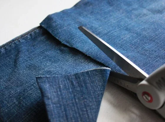 scissors cutting into denim