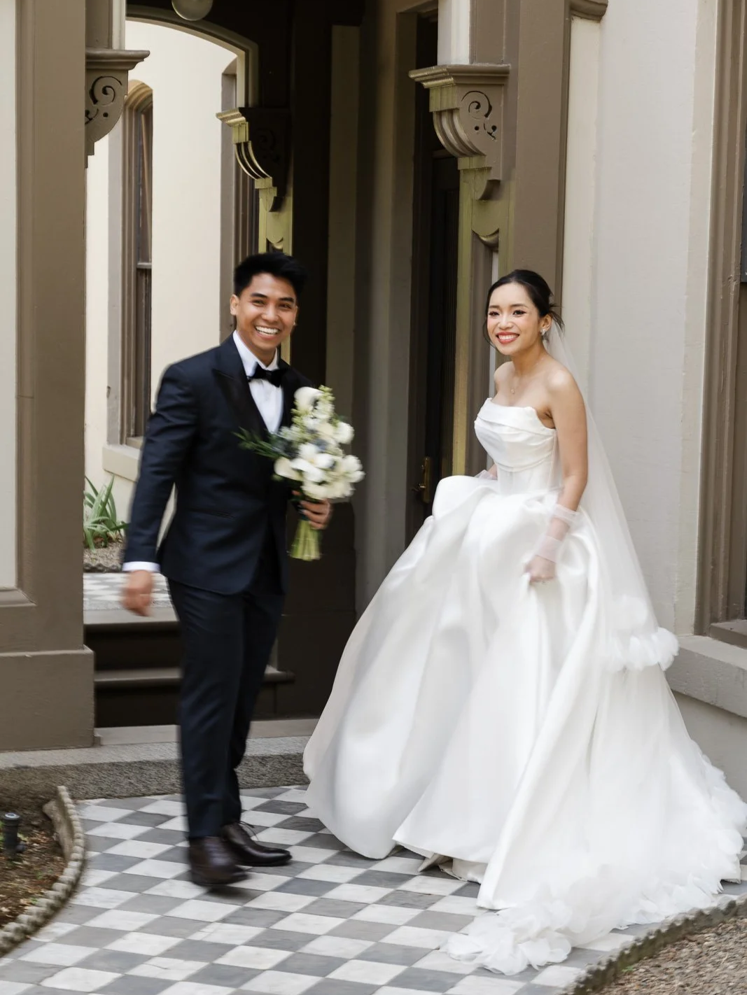 bride and groom smiling at the camera