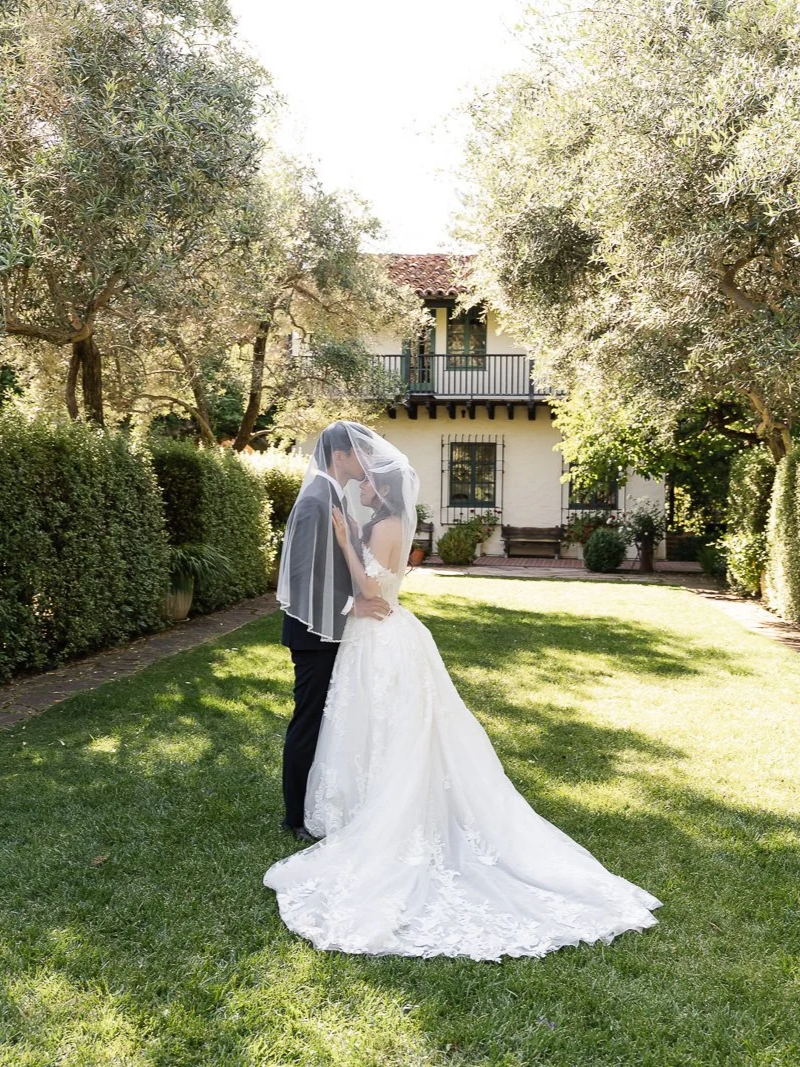 couple under bride's veil in Allied Arts Guild