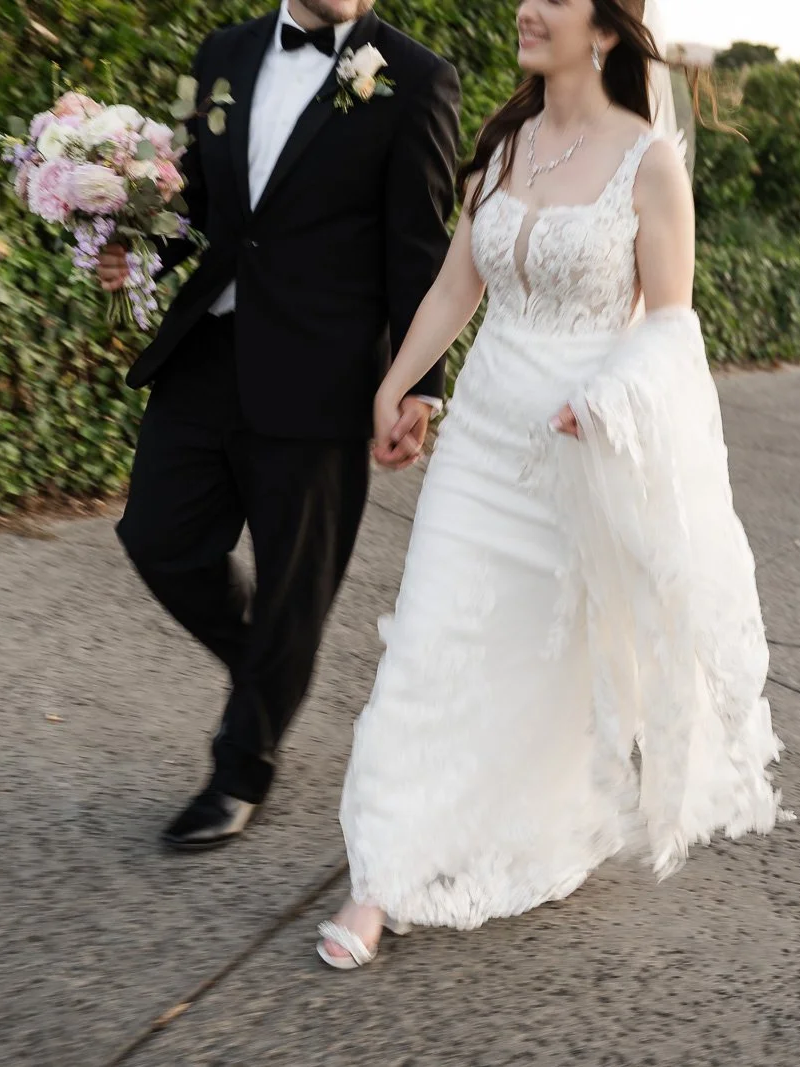 Bride and groom walking candid photo