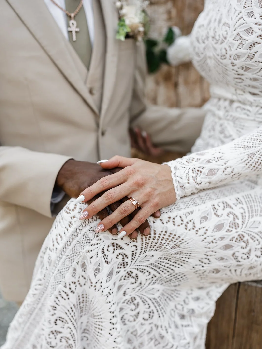 close up photo of bride and grooms hands and wedding rings