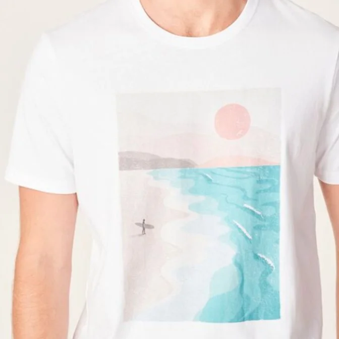 White T-shirt with a graphic of a beach scene featuring a pink sun, light mountains, and turquoise ocean waves.