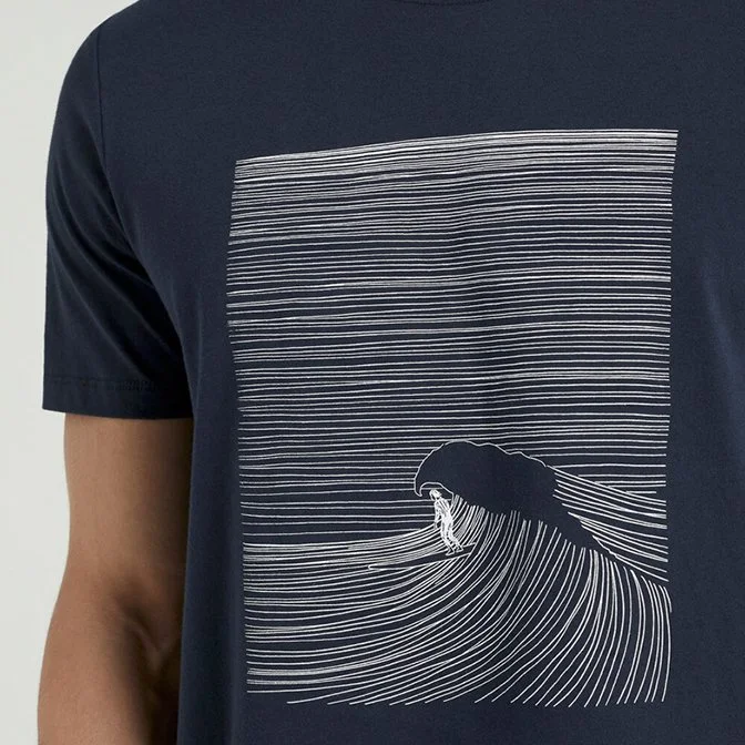 Close-up of a navy blue T-shirt with a graphic of a wave and a person riding it, depicted with white lines.