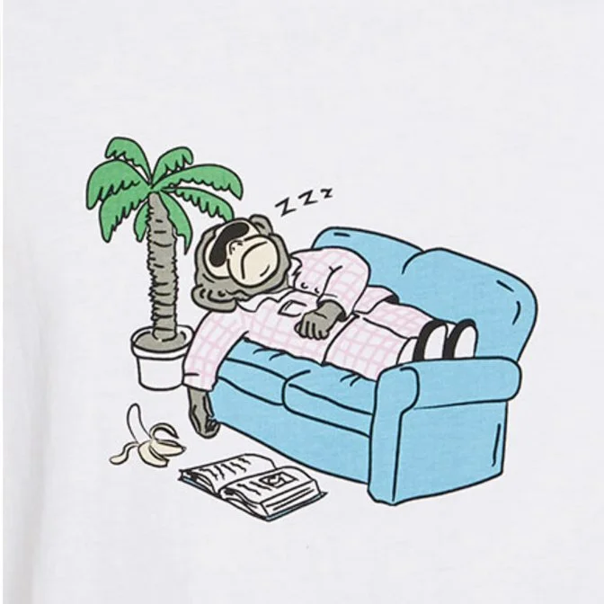 A cartoon gorilla sleeping on a blue couch, wearing pink pajamas, with a small palm tree in a pot beside it, a banana peel on the floor, and an open magazine nearby.