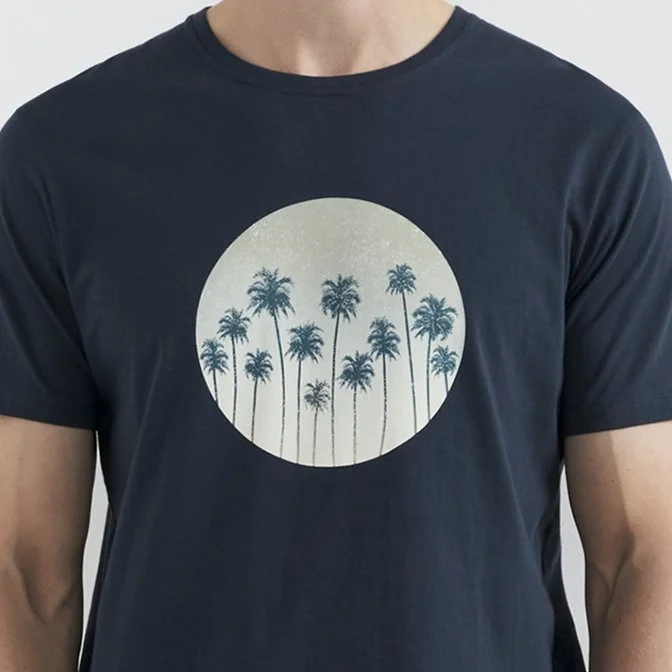 Black T-shirt with a circular graphic of palm trees inside