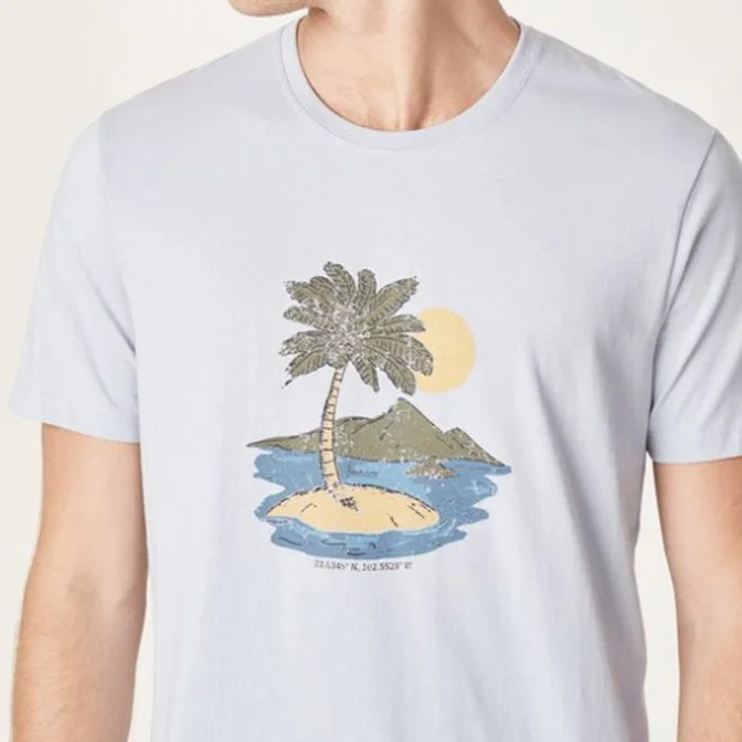 A person wearing a light-colored T-shirt with a graphic of a tropical island scene, featuring a palm tree, water, and mountains, with a yellow sun in the background.