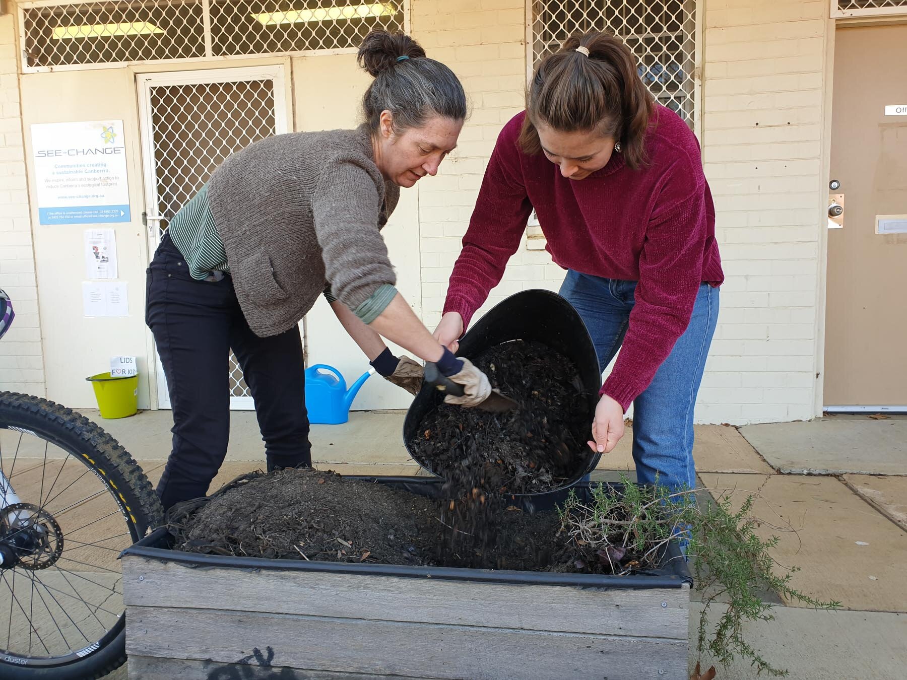 Brook _ Maddie adding compost to garden beds.jpg