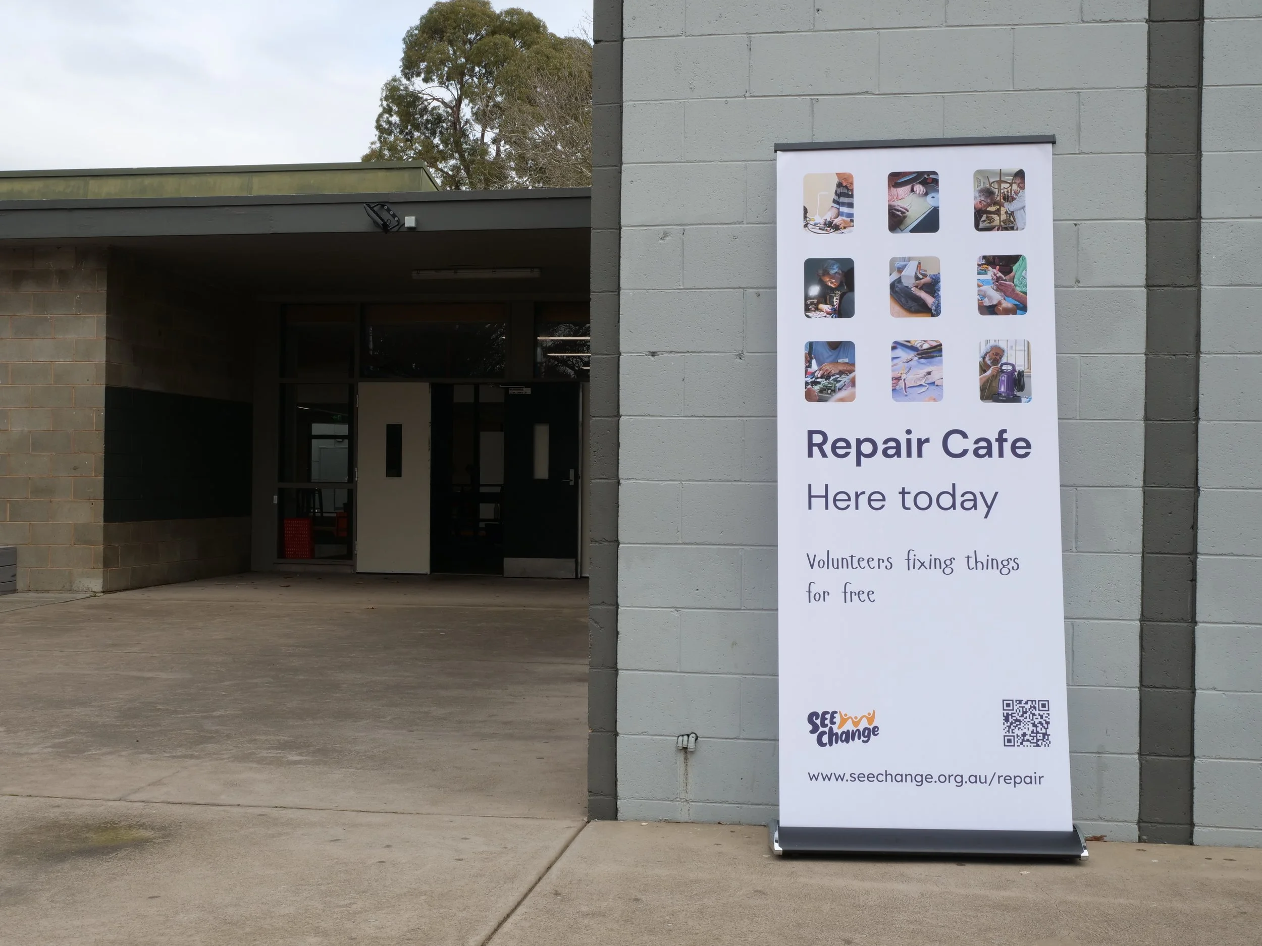 Repair cafe banner outside of school.