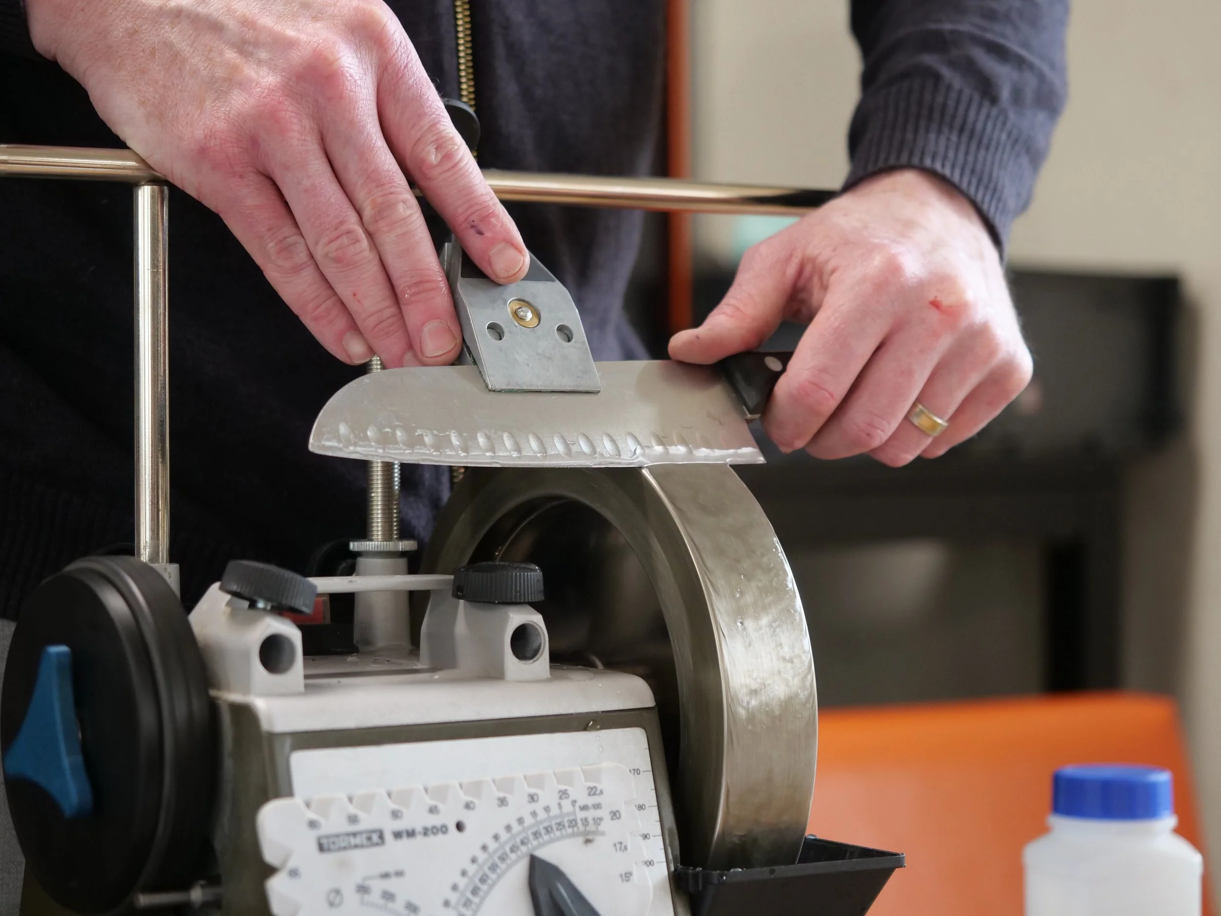 Hands sharpening knife.