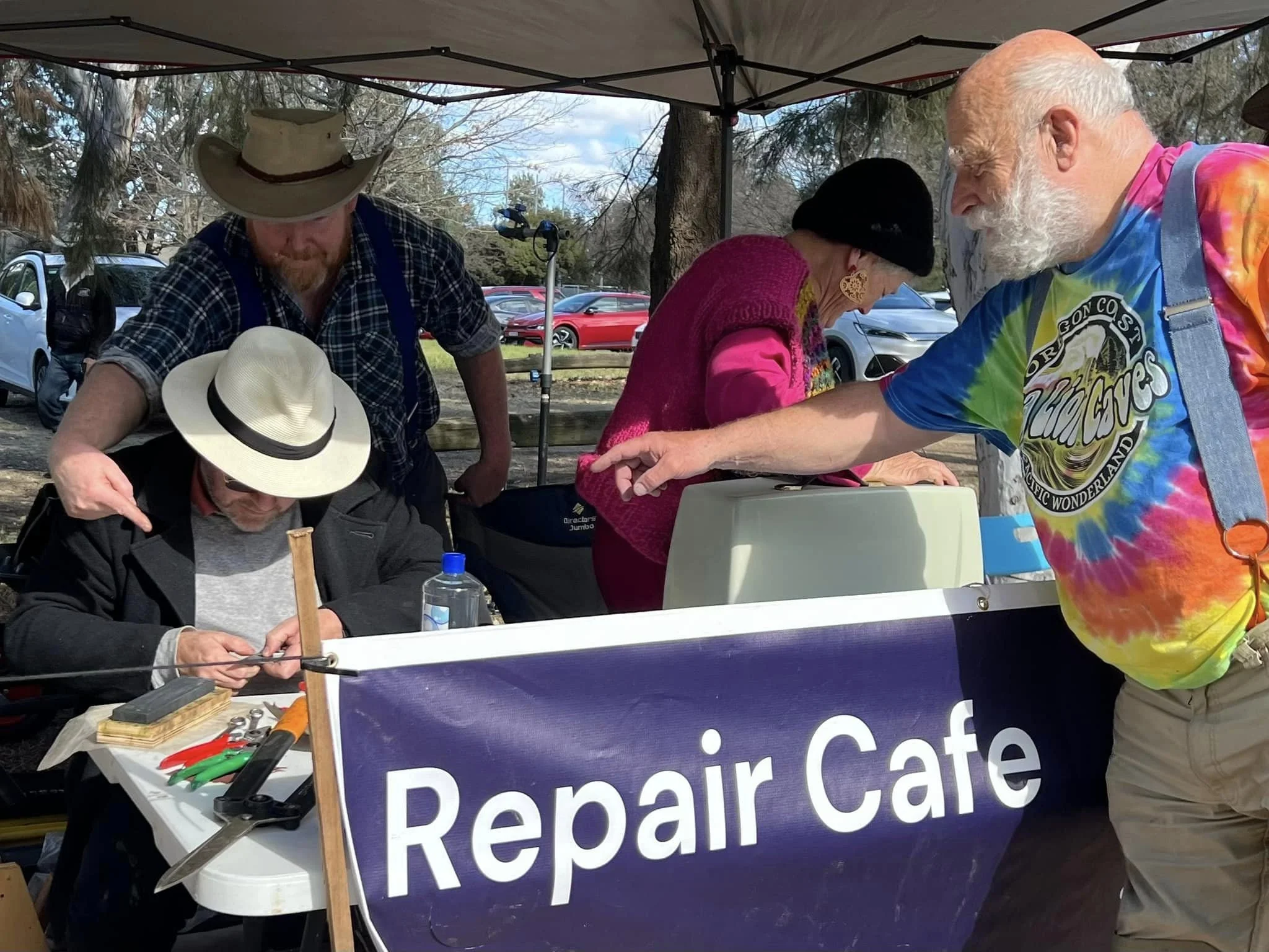 Repair cafe stall with repairers.