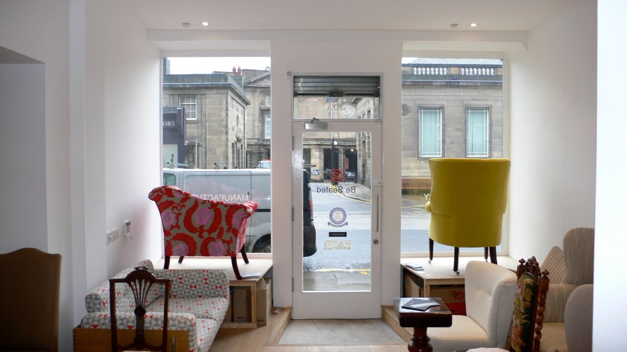  Examples of upholstery work are on display in the shopfront. 