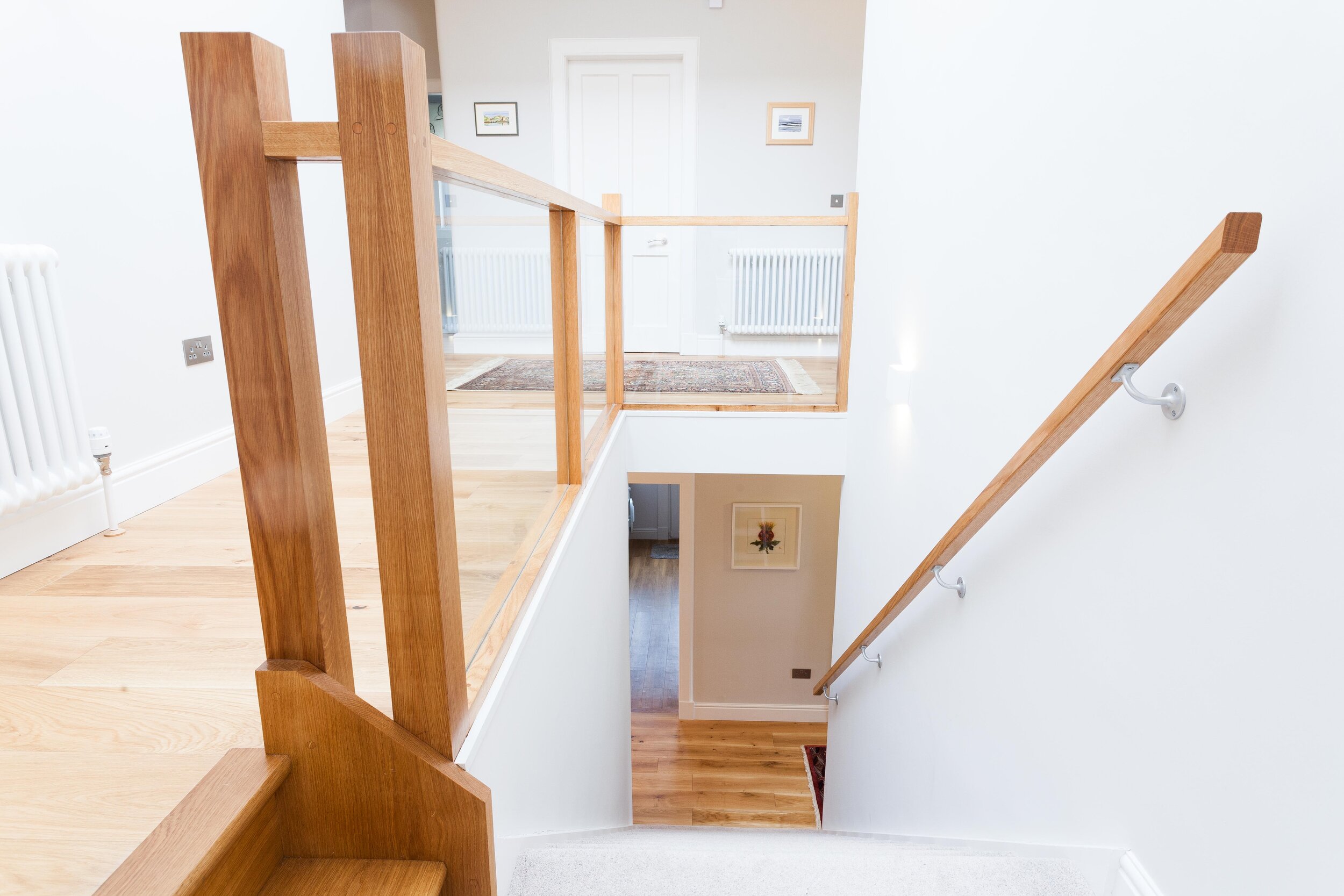  A glass balustrade allows natural light to reach the ground floor hall. 