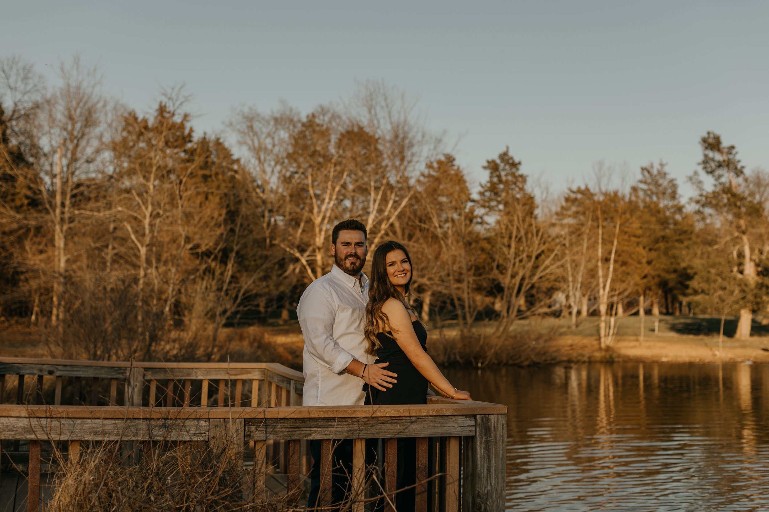 A newly engaged couple taking engagement photos at Claude Moore Park in Sterling, Virginia