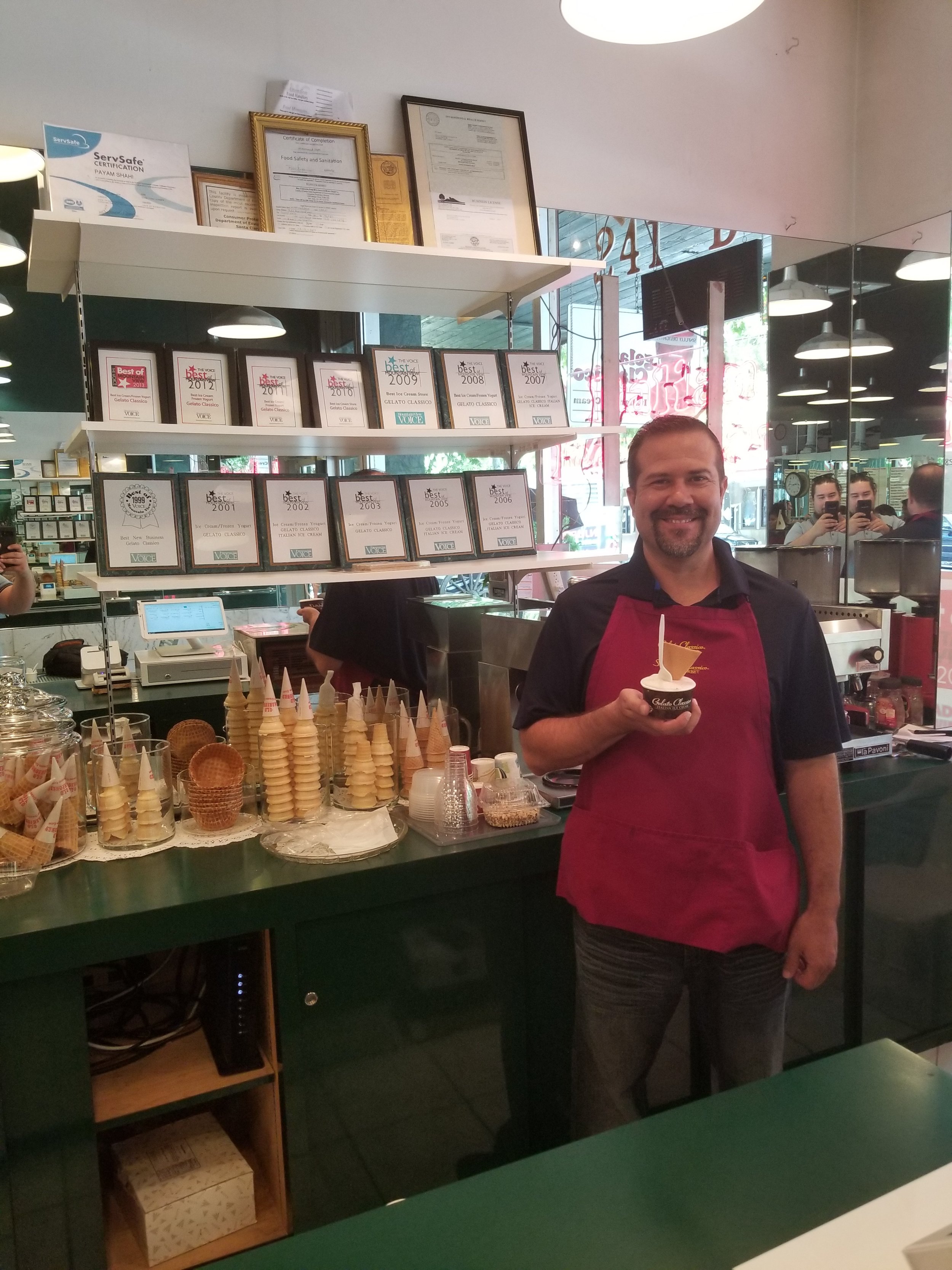 A smiling Gelato Classico employee.