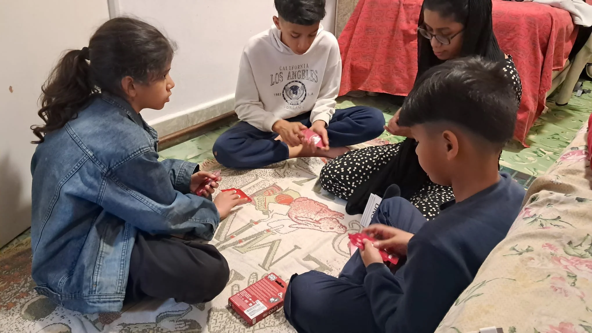 Els infants de Càritas gaudeixen dels jocs d’UNO donats de forma altruista pel mag Óscar de la Torre