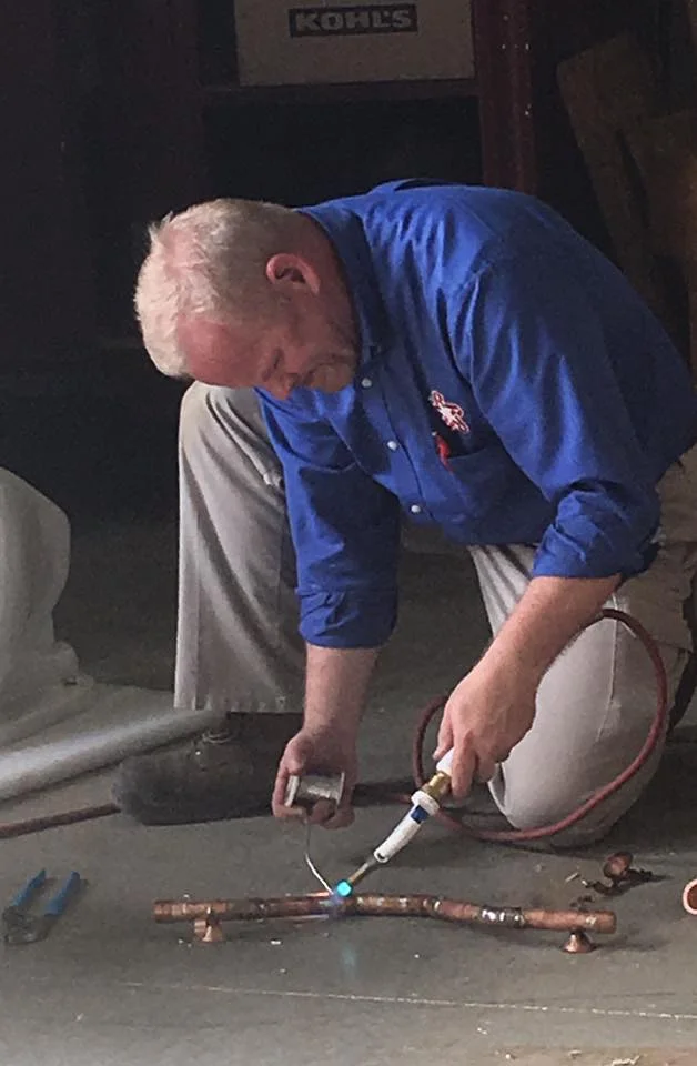 Student Ron Faulkner completing the soldering portion of his plumbing journeyman licensing examination