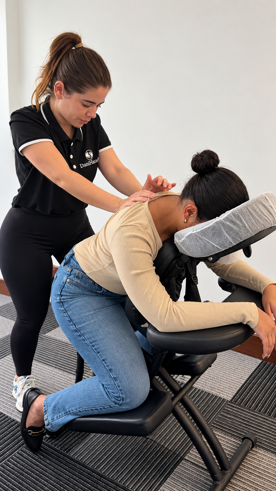A woman receiving a massage or chiropractic adjustment from a professional therapist in an office or clinic setting.