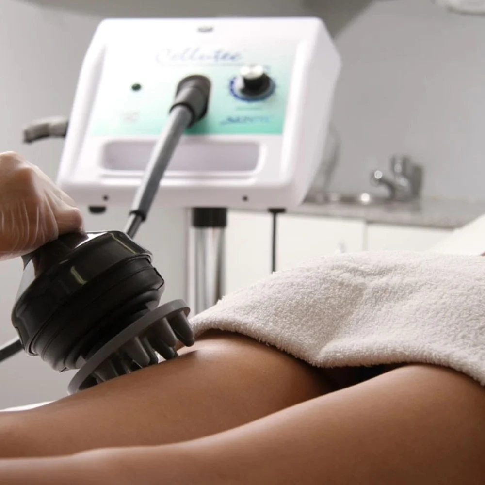 A person receiving a massage with a device on their back in a clinical setting.