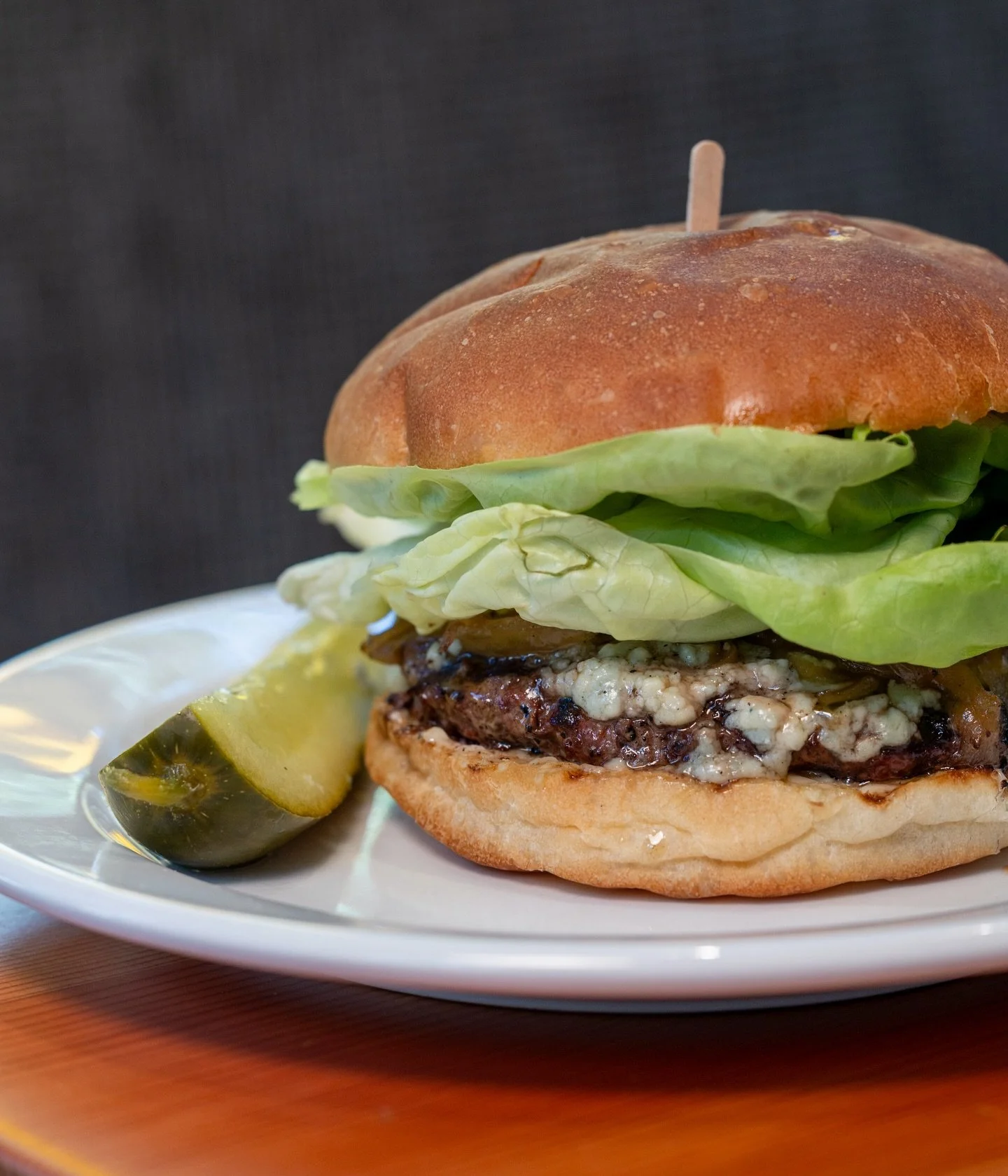 Point Reyes Blue Cheese Burger with caramelized onions, butterleaf lettuce, and mayonnaise. Rich, savory, and very Caf&eacute; Bernardo.