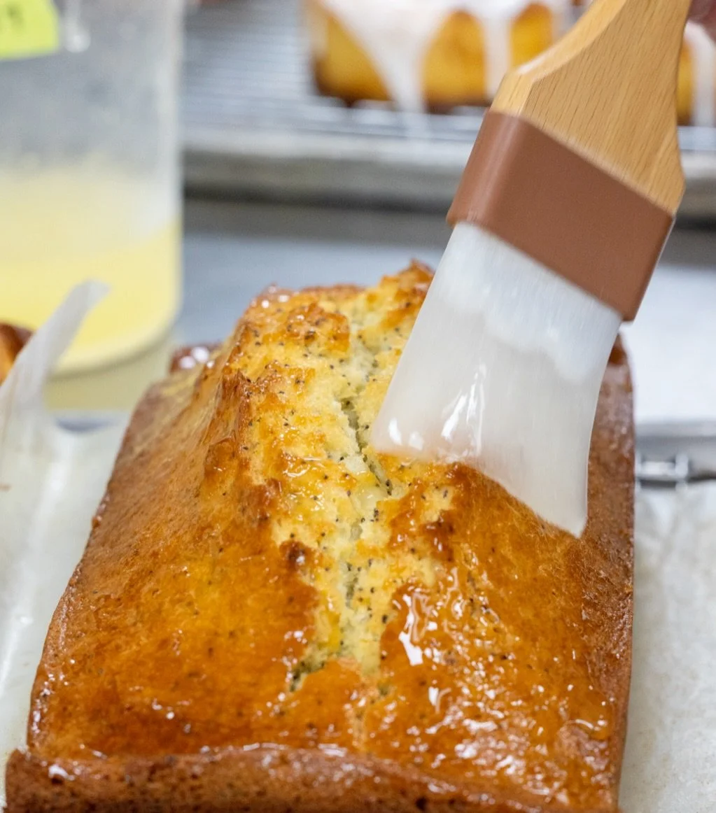 The finishing touch. 🍋 Freshly glazed Lemon Poppyseed Bread, baked in-house daily.