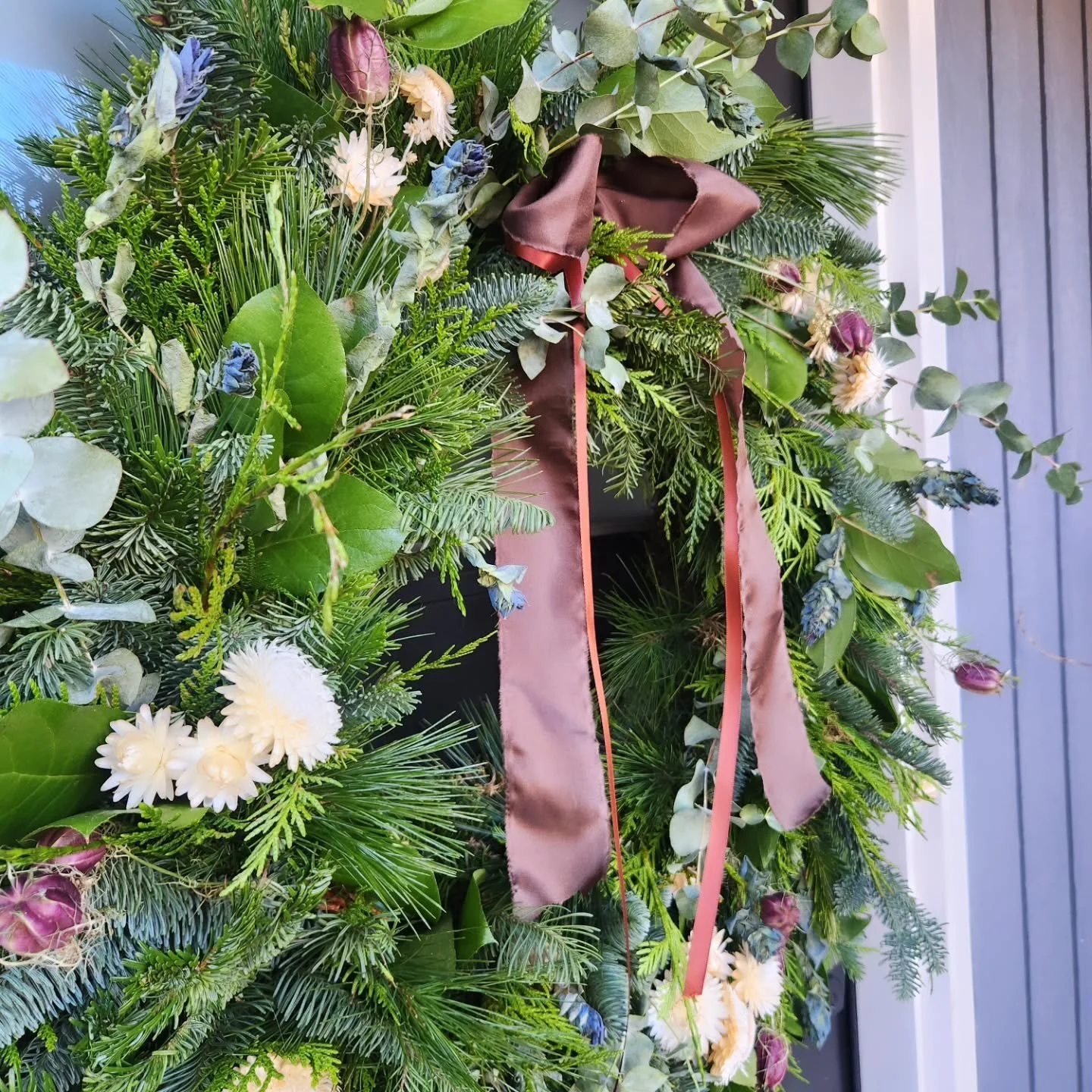 Dimension and texture make or break a wreath. Whether it's meant to be wild and unruly, or uniform and formal, it's just plain flat without dimension and texture. If you're making your own, keep your bundles packed close together, and ALWAYS add one 